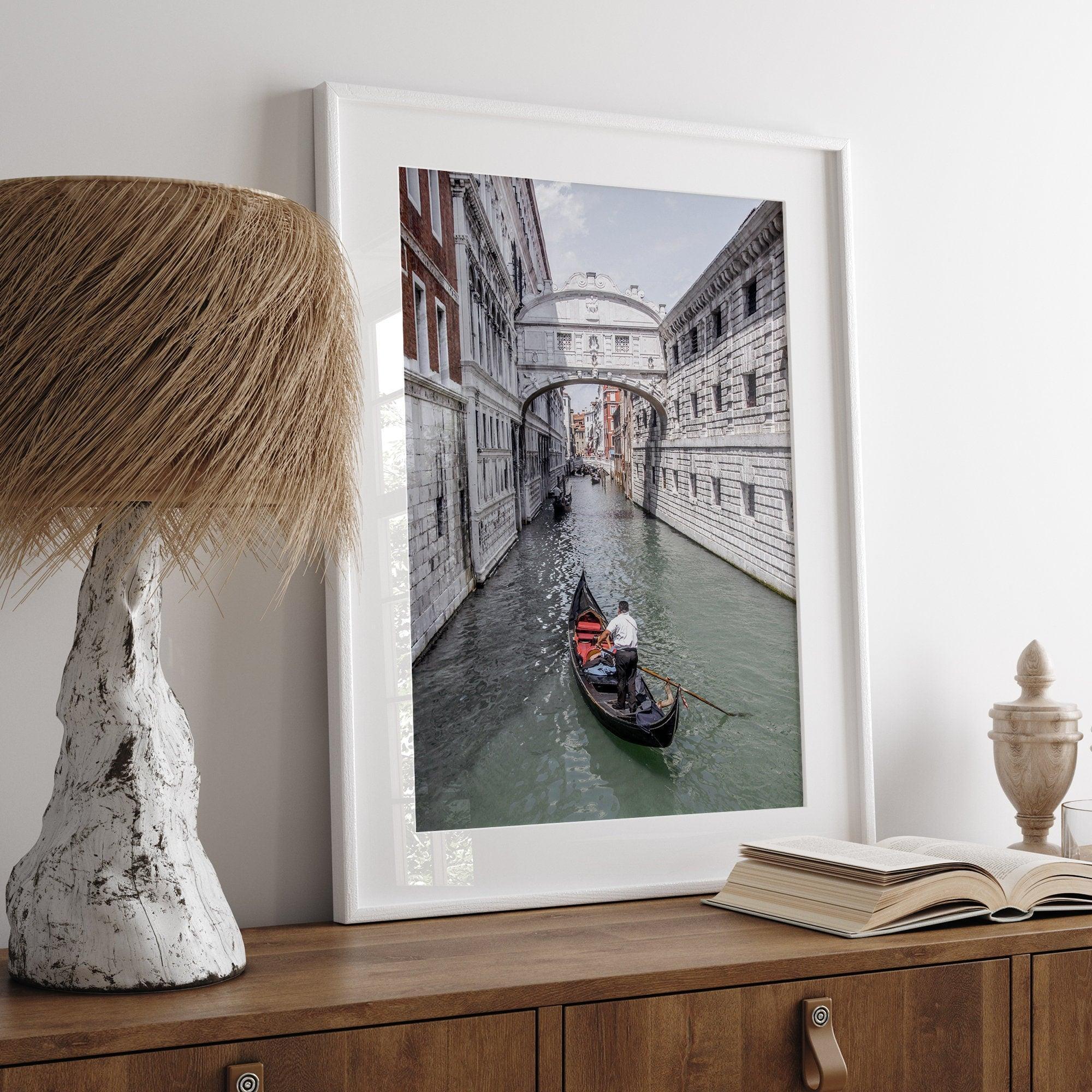 A fine art Venice travel print framed or unframed poster showcasing a Goldola sailing in one of the narrow canals of the old cities of Italy.