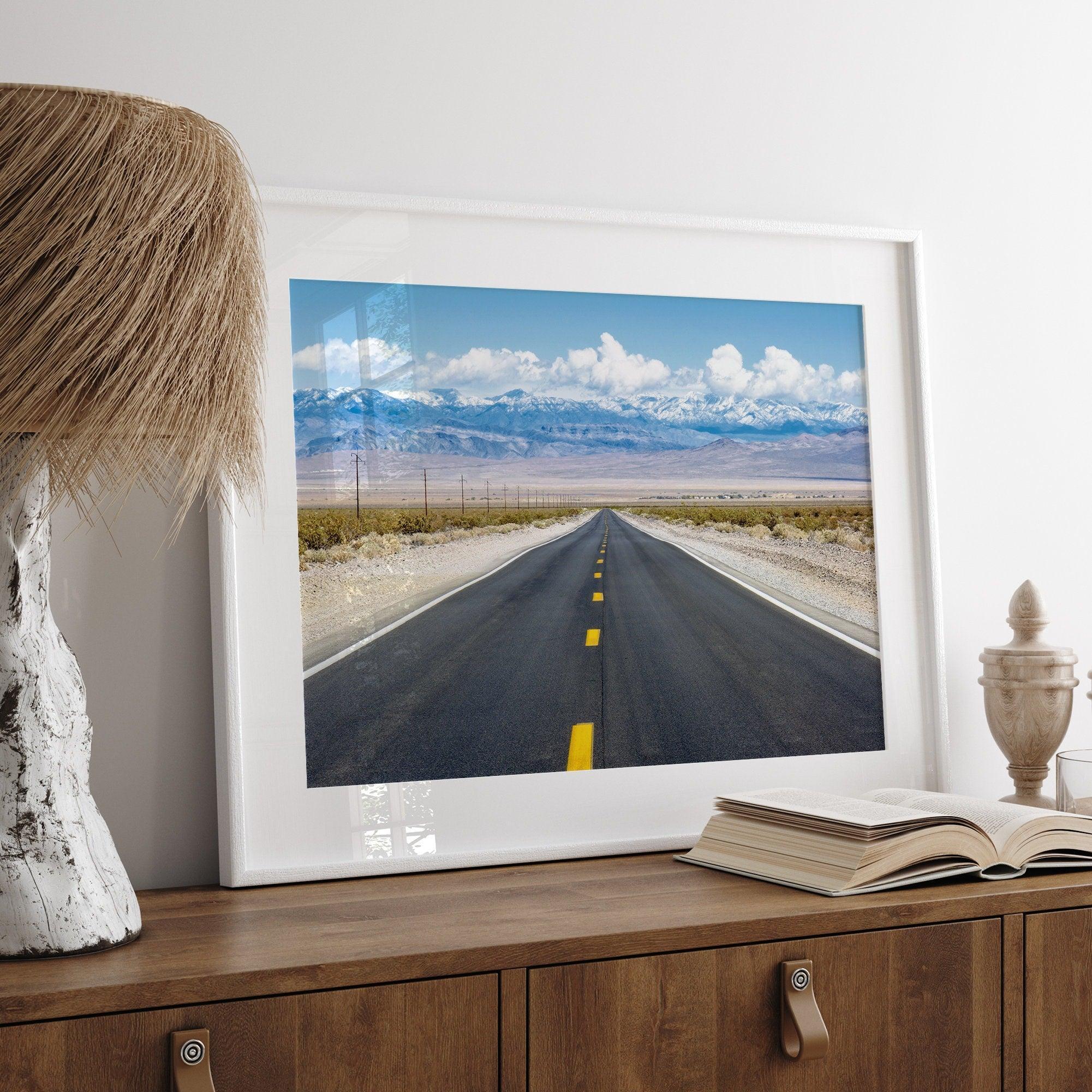 This stunning piece of desert wall art will take your breath away. This beautifully framed picture of a Death Valley National Park road leading towards the snow-covered mountains at the end of the desert will impress when hung on your walls.