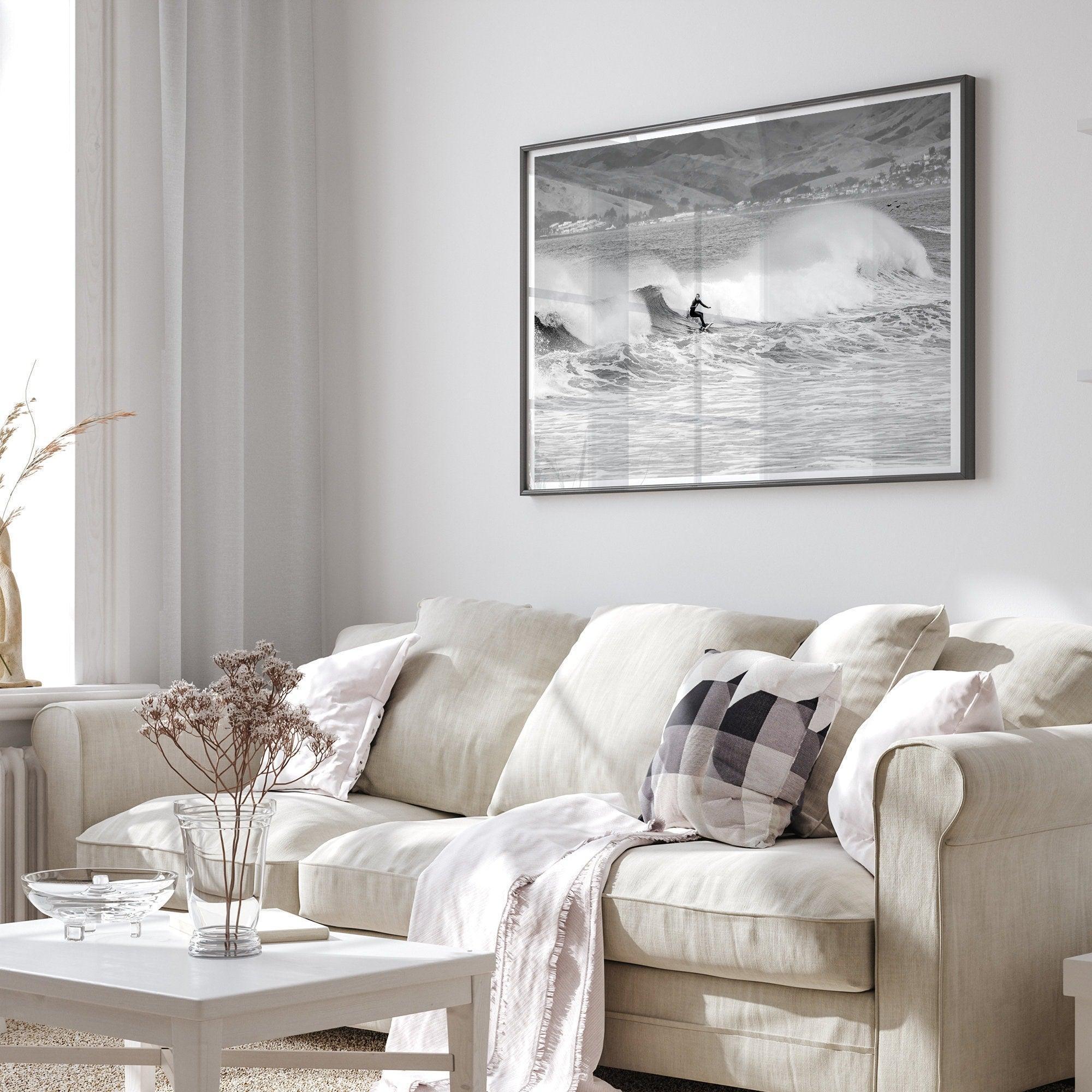 A black and white fine art surf print. This ocean wall art showcases a lone surfer riding the waves in Pismo Beach, California.