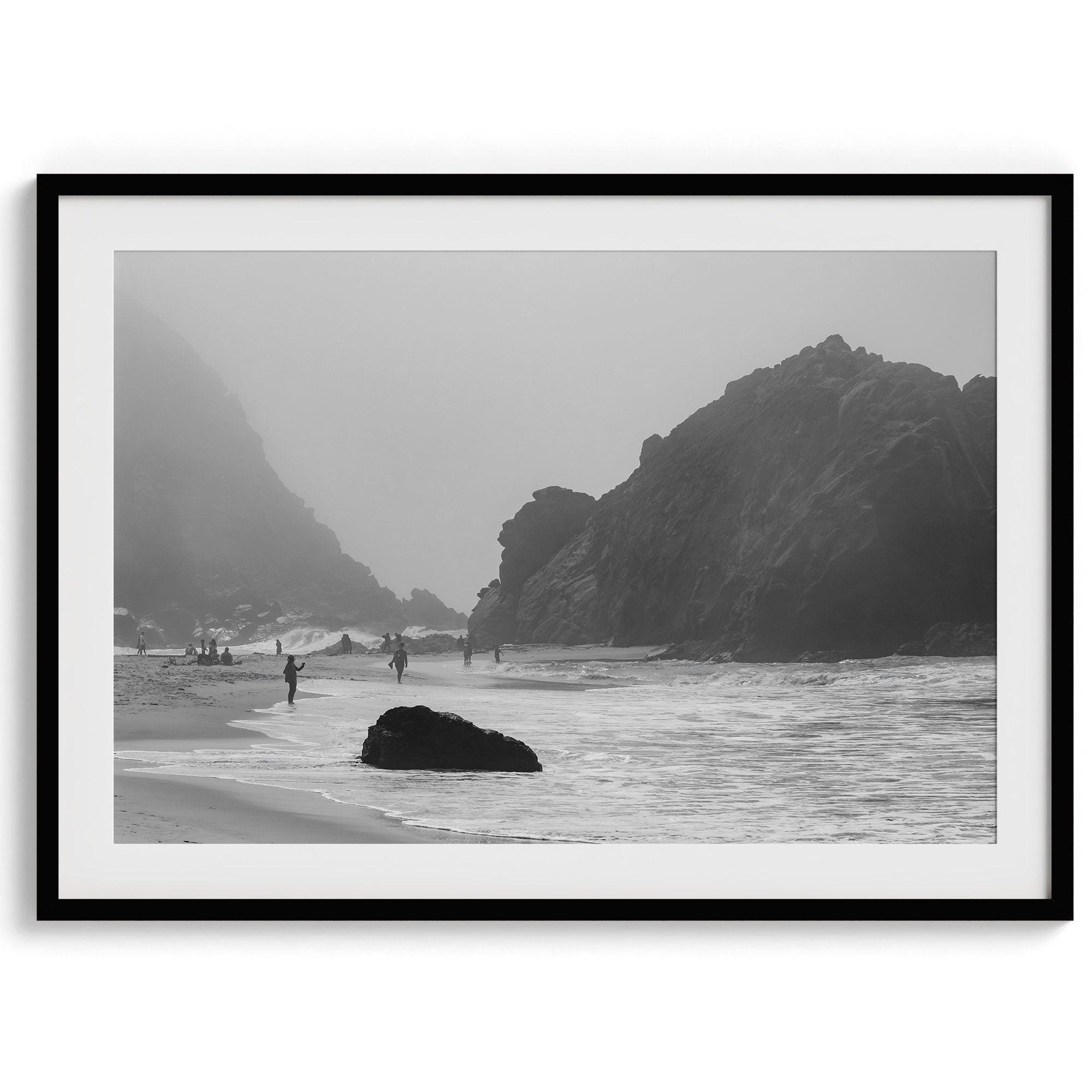 A framed black and white print of the beautiful Pfeiffer Beach in Big Sur hung in the living room. This wall art showcases the dramatic rocks and mist of the Big Sur coastline and the day-to-day life of the beach.