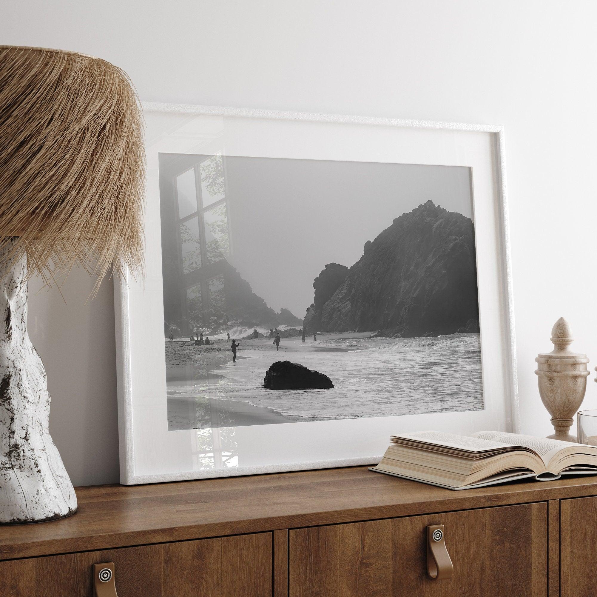 A framed black and white print of the beautiful Pfeiffer Beach in Big Sur hung in the living room. This wall art showcases the dramatic rocks and mist of the Big Sur coastline and the day-to-day life of the beach.