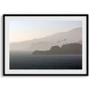 This fine art coastal photography print showcases two birds majestically flying over the Pacific Ocean towards the layered Marin mountains in the sunset. On one of the ridges, there is a lighthouse. The photo was taken from Lands End San Francisco.
