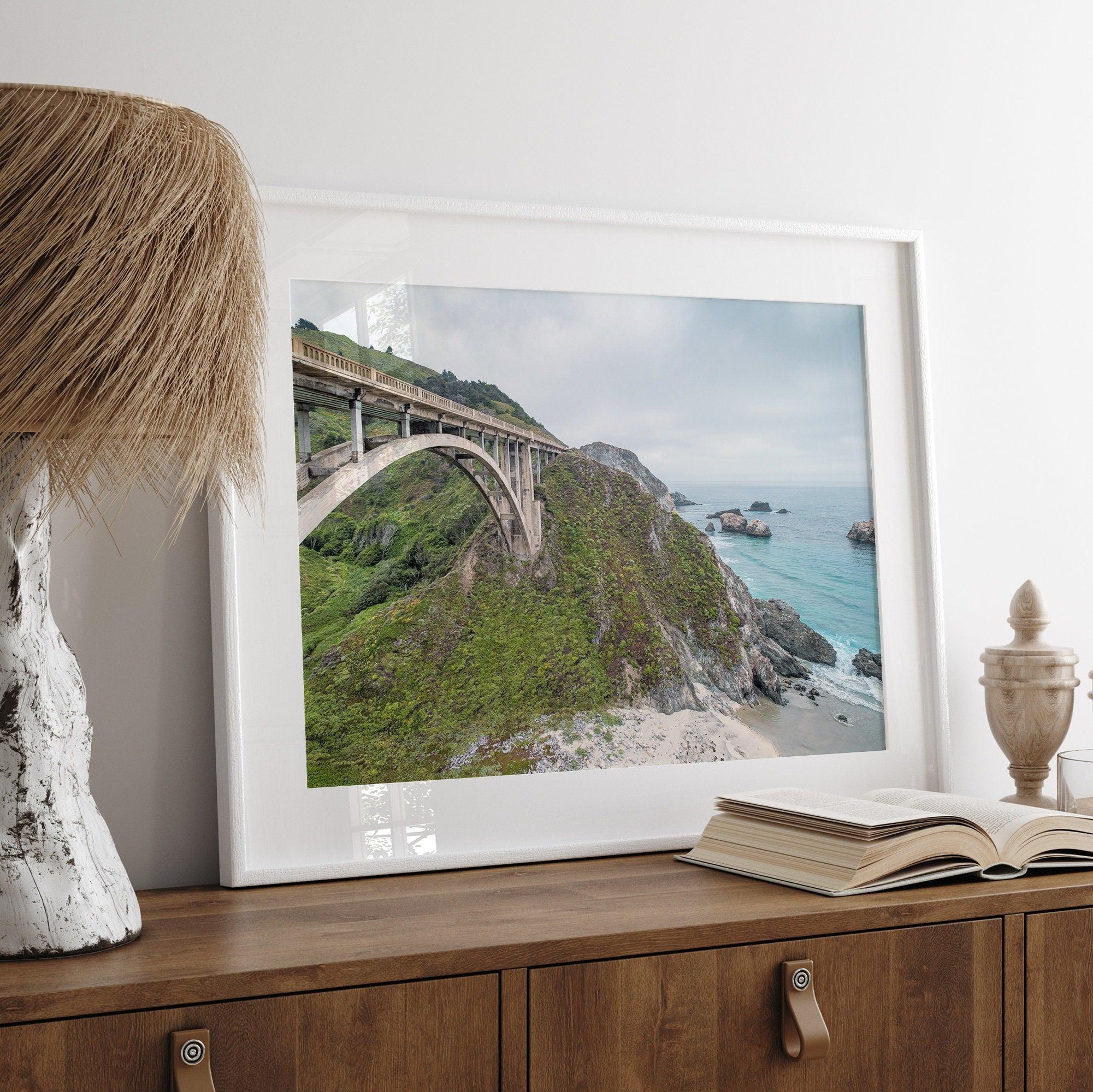 A fine art ocean print of one of the most iconic spots in the famous Route 1 in California - Bixby Bridge near Big Sur. Shot in a unique wide angle that captures the bridge, cliffs, the ocean, and the stunning beach below.