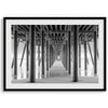 A large fine art abstract black and white beach pier print This stunning beach wall art shows the symmetric structure of the pier with the ocean water gently caressing the pier and beach.