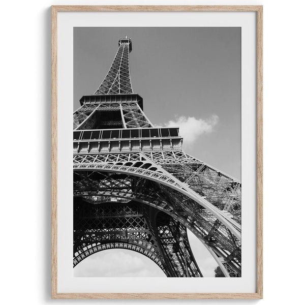 A fine art Eiffel Tower black and white print. This Paris theme wall art showcases a unique wide-angle view from the bottom of the tower, creating a modern, trendy fine art photography to hang on your walls.