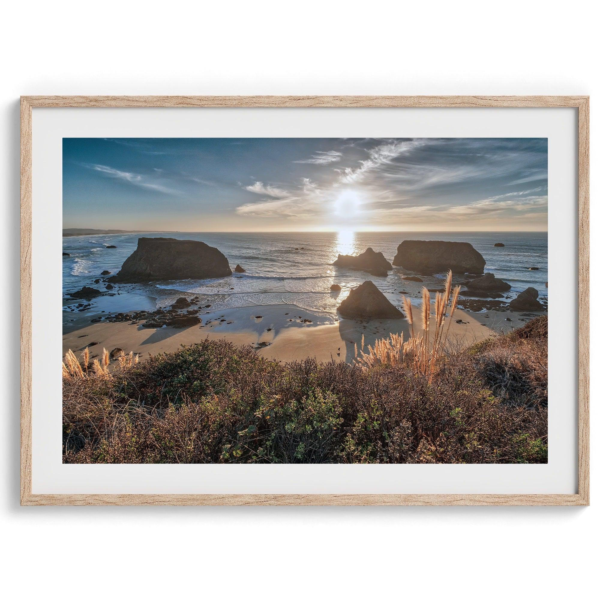 A fine art unframed or framed beach print showing the breathtaking beach of Fort Bragg, California, as the sunset ray of lights hits the ocean and the vast sea stacks.