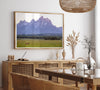 A stunning snow-covered mountain framed or unframed print from Grand Teton National Park with a beautiful horse grazing the grass in the forefront.