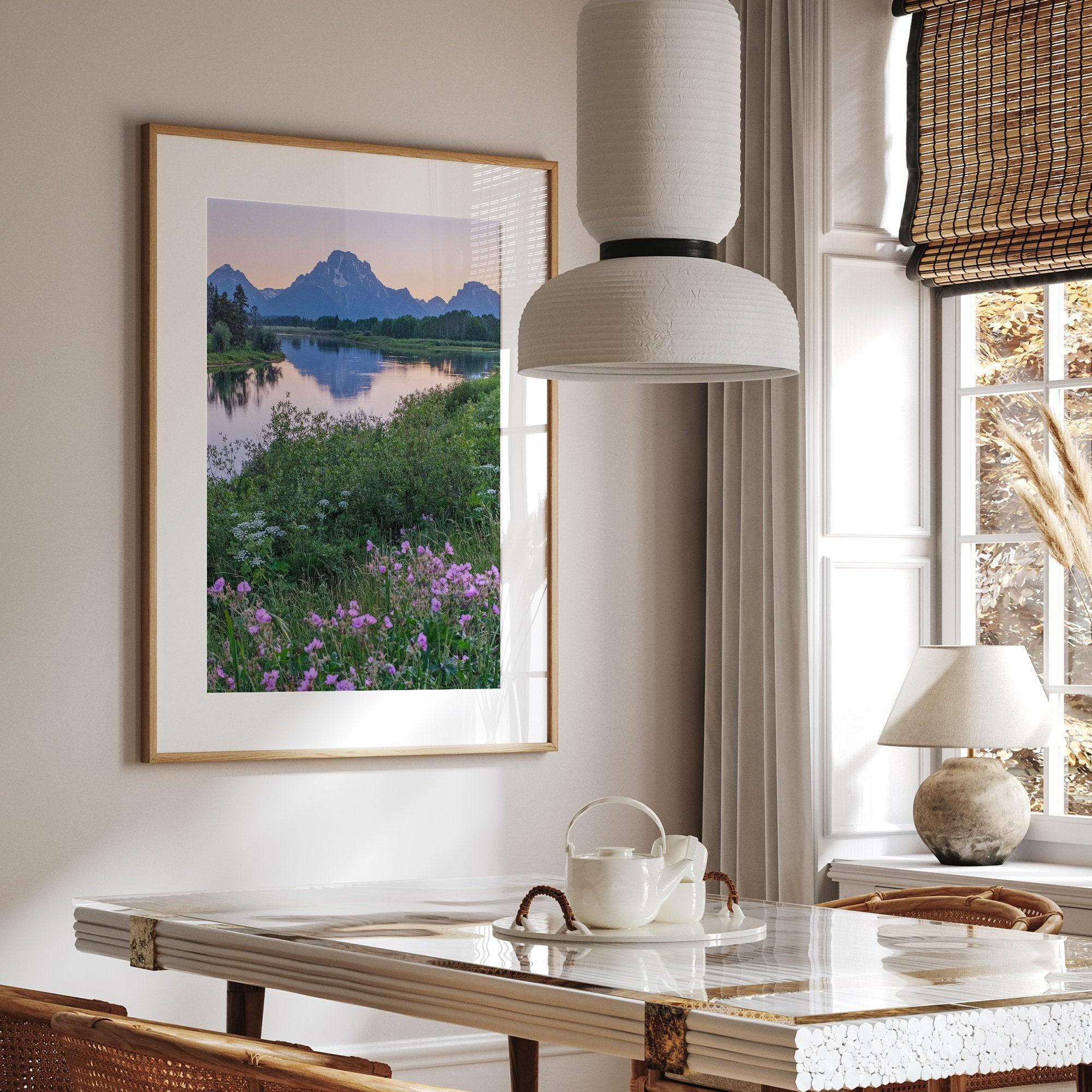 A fine art framed or unframed mountain print of Grand Teton National Park. This portrait orientation nature landscape wall art showcases the beautiful Teton mountains in a pink sunset, with Snake River and stunning flowers in the forefront.