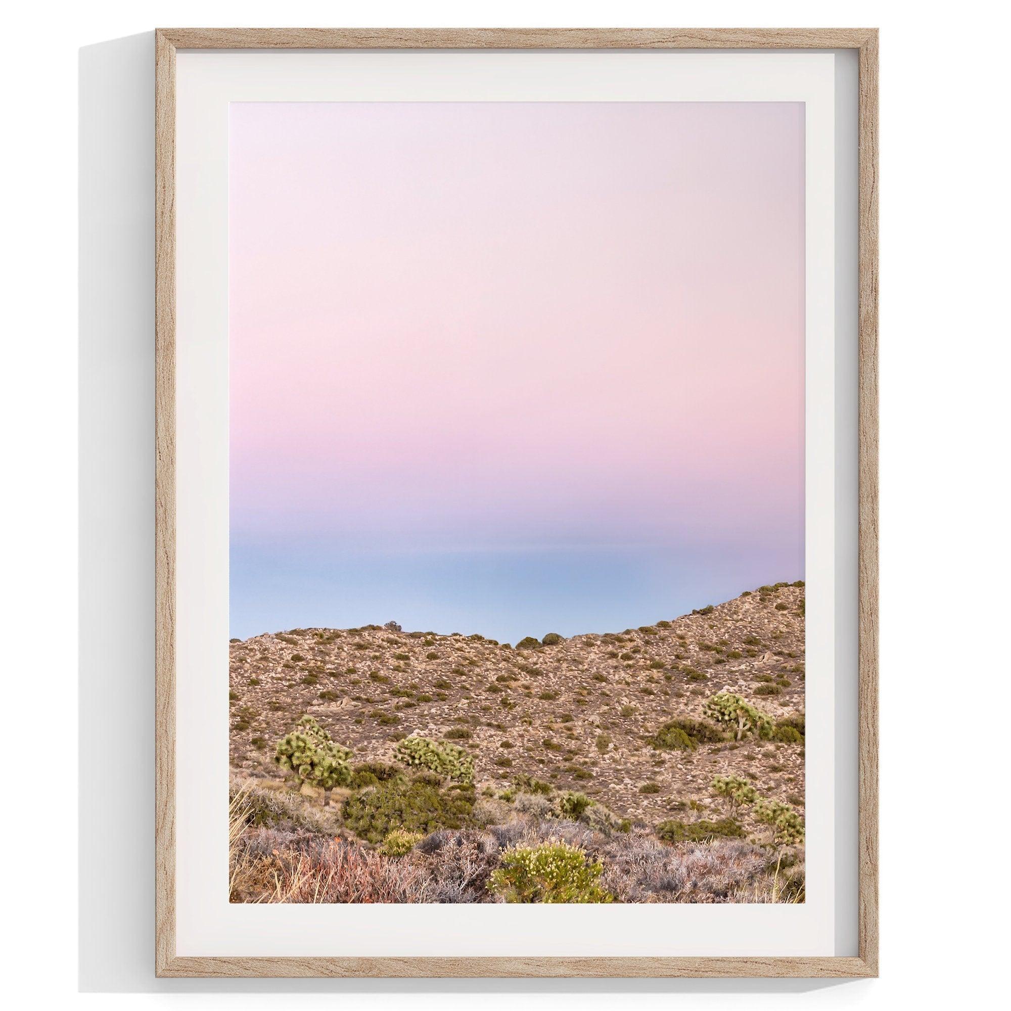 A wall art set of 3 framed or unframed Joshua Tree National Park prints. This desert wall art showcases a stunning Joshua Tree and the desert terrain and plants in a breathtaking Pink sunset filled with Pink and Purple hues. Modern gallery wall set