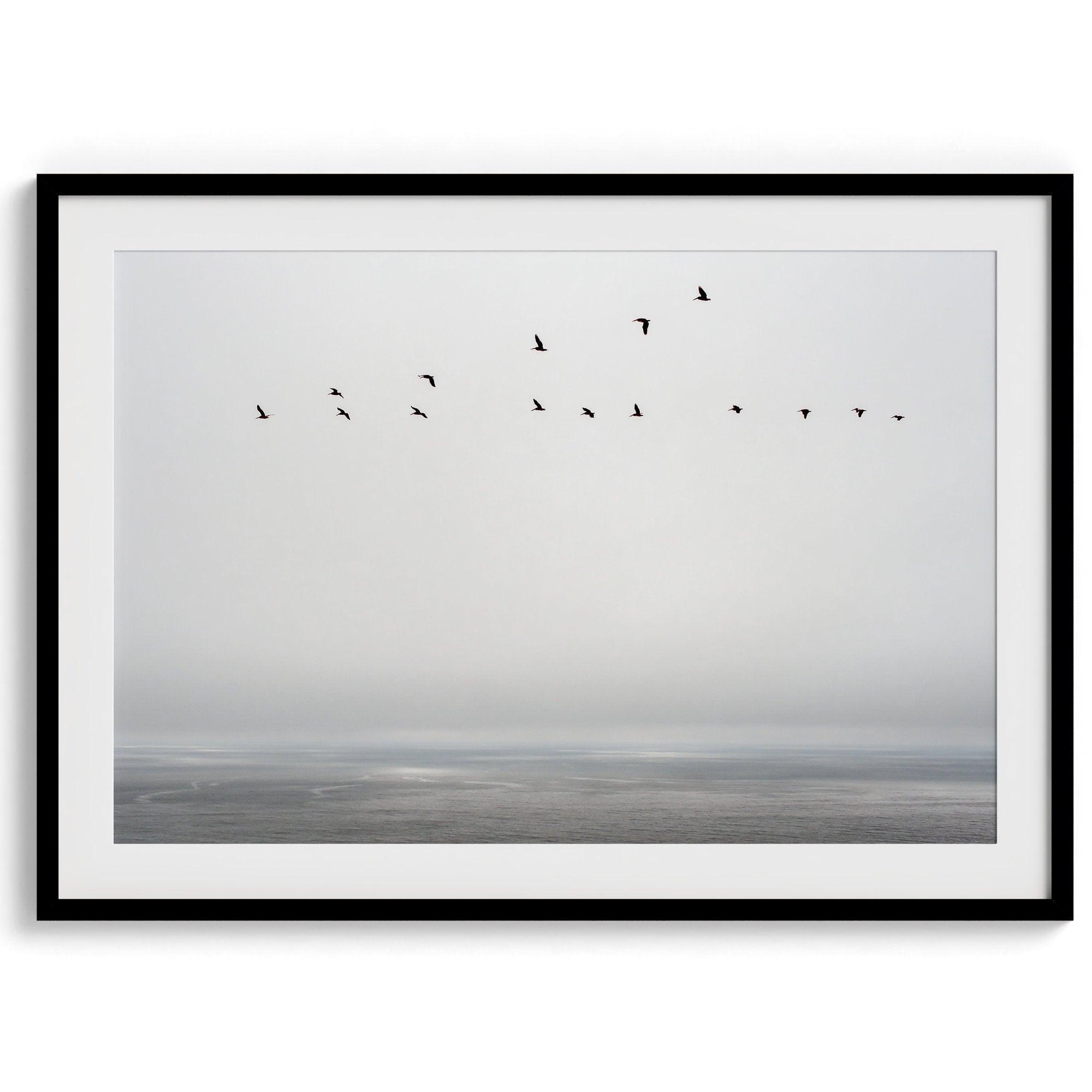 This fine art minimalist ocean print showcases pelicans flying across the Pacific Ocean in Pacifica, California.