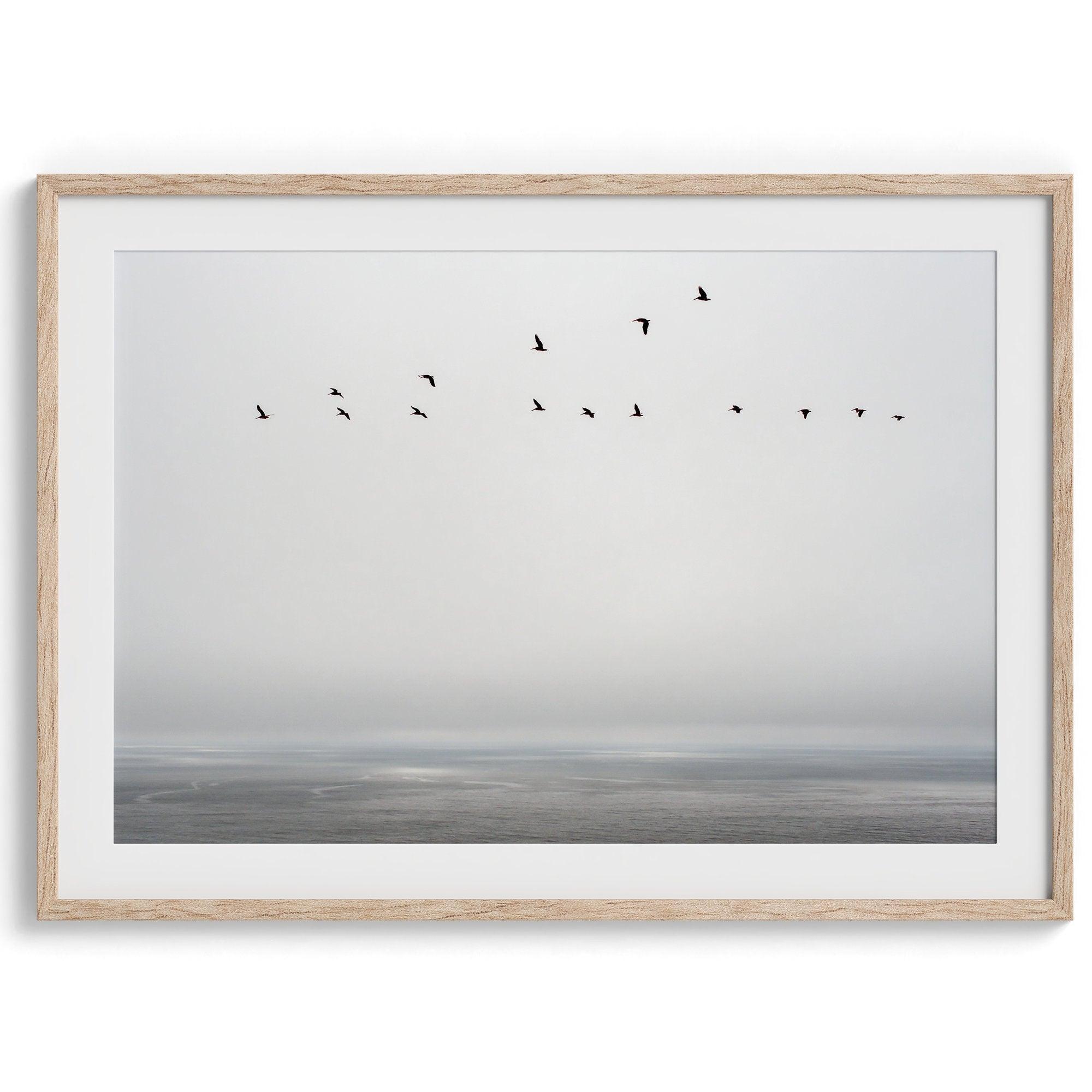 This fine art minimalist ocean print showcases pelicans flying across the Pacific Ocean in Pacifica, California.