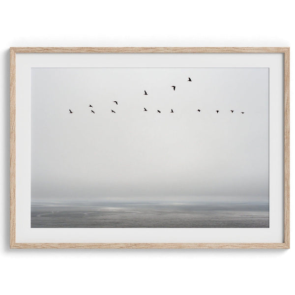 This fine art minimalist ocean print showcases pelicans flying across the Pacific Ocean in Pacifica, California.