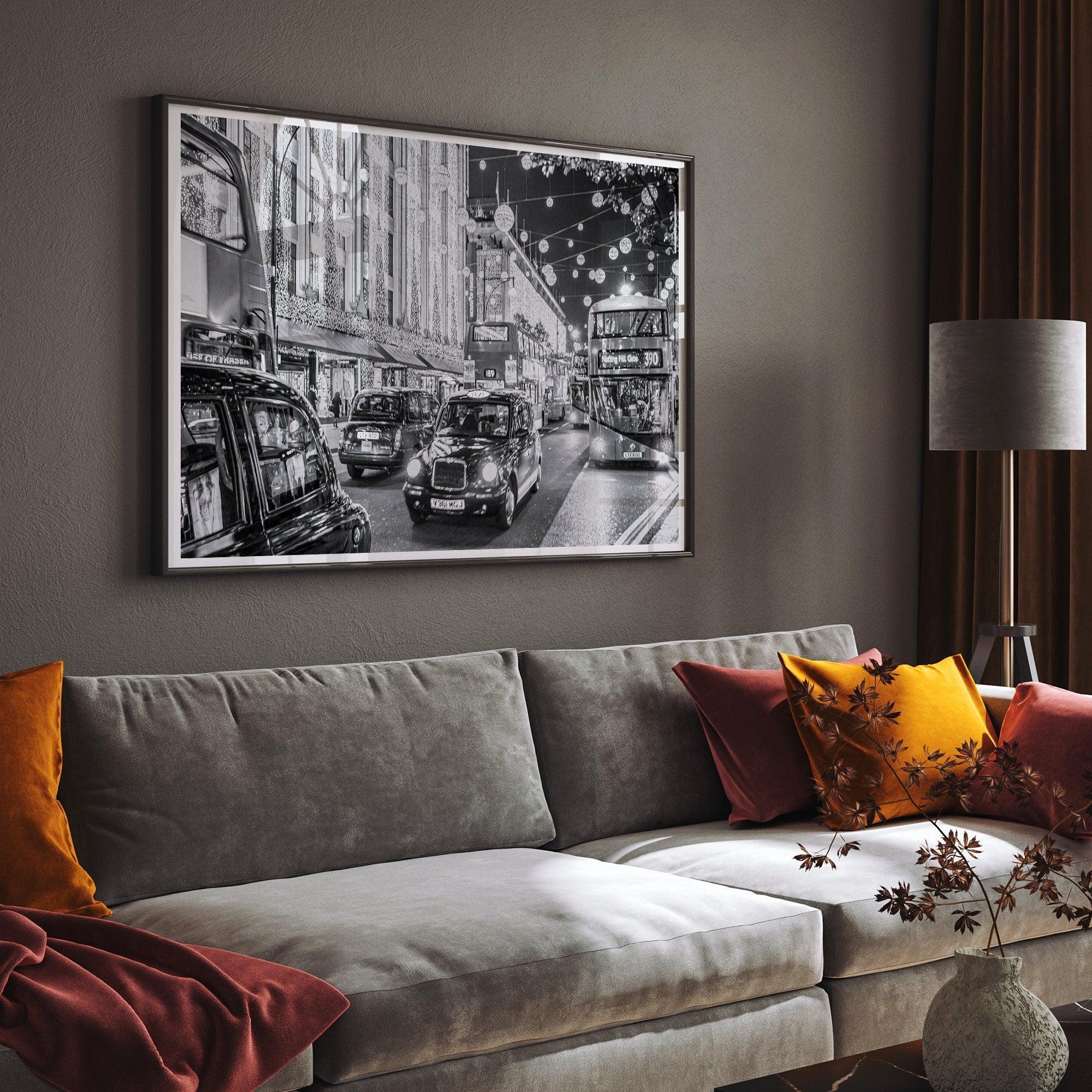 A fine art black and white photography print of a vibrant street in London during the Christmas holidays. This London wall art shows double-decker buses and black taxis, and the streets are adorned with bright holiday lights and festive decorations