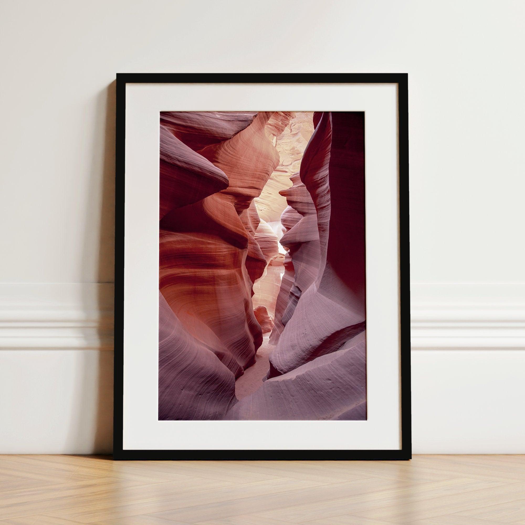 This beautiful Arizona desert wall art captures the mesmerizing beauty of Antelope Canyon. The picture showcases a passage through the rock in the canyon, with vibrant pink and purple textures that create a sense of depth and dimension.