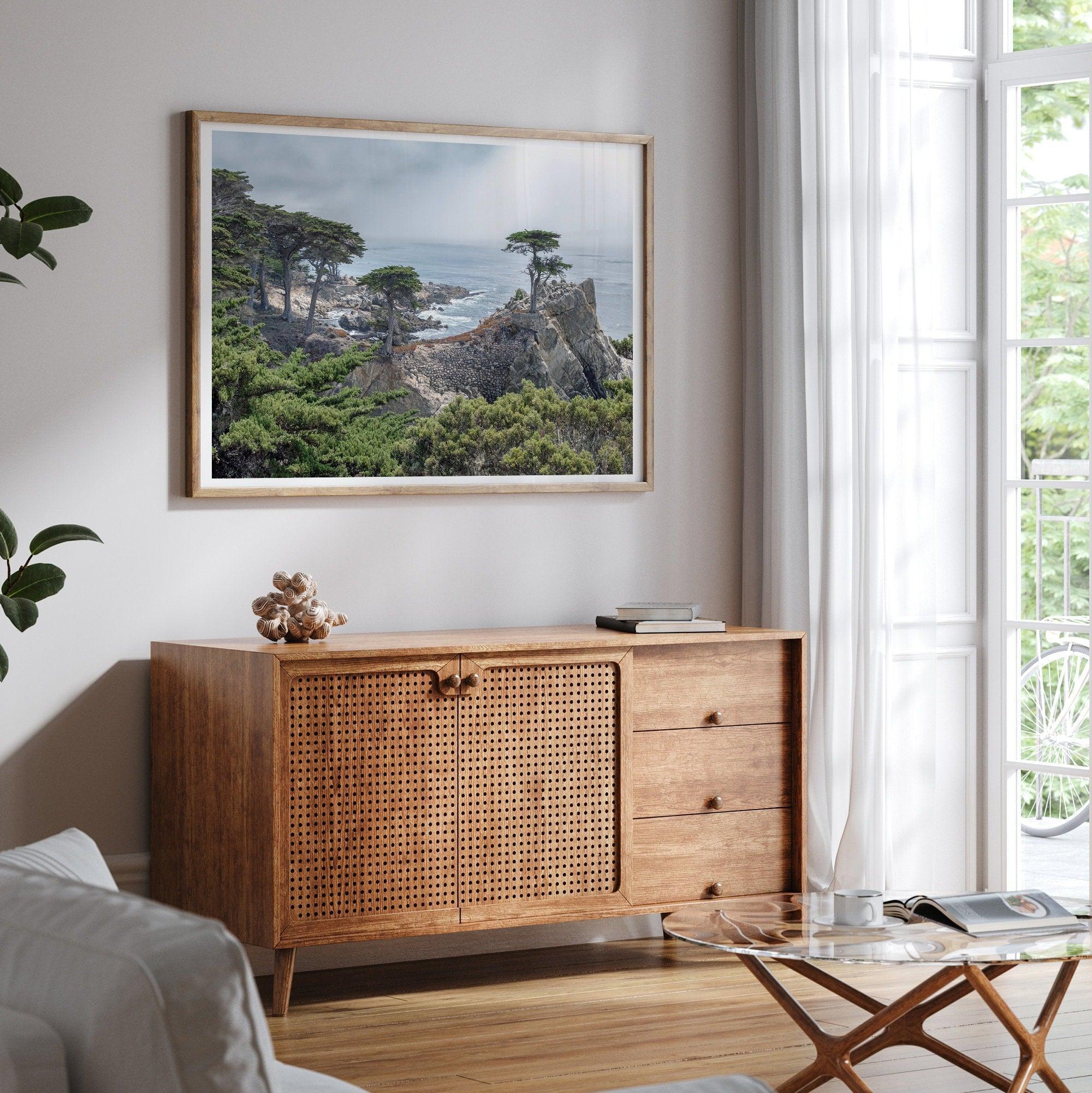 A fine art coastal print showcasing a lone cypress overlooking the ocean in 17 miles drive near Monterey, California. This ocean wall art is available framed or unframed.