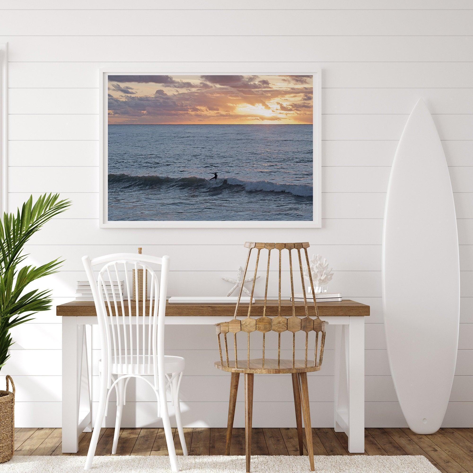 A fine art ocean sunset print showcasing a serene sunset and a lone surfer riding the waves. Taken in Montana De Oro State Park, California.