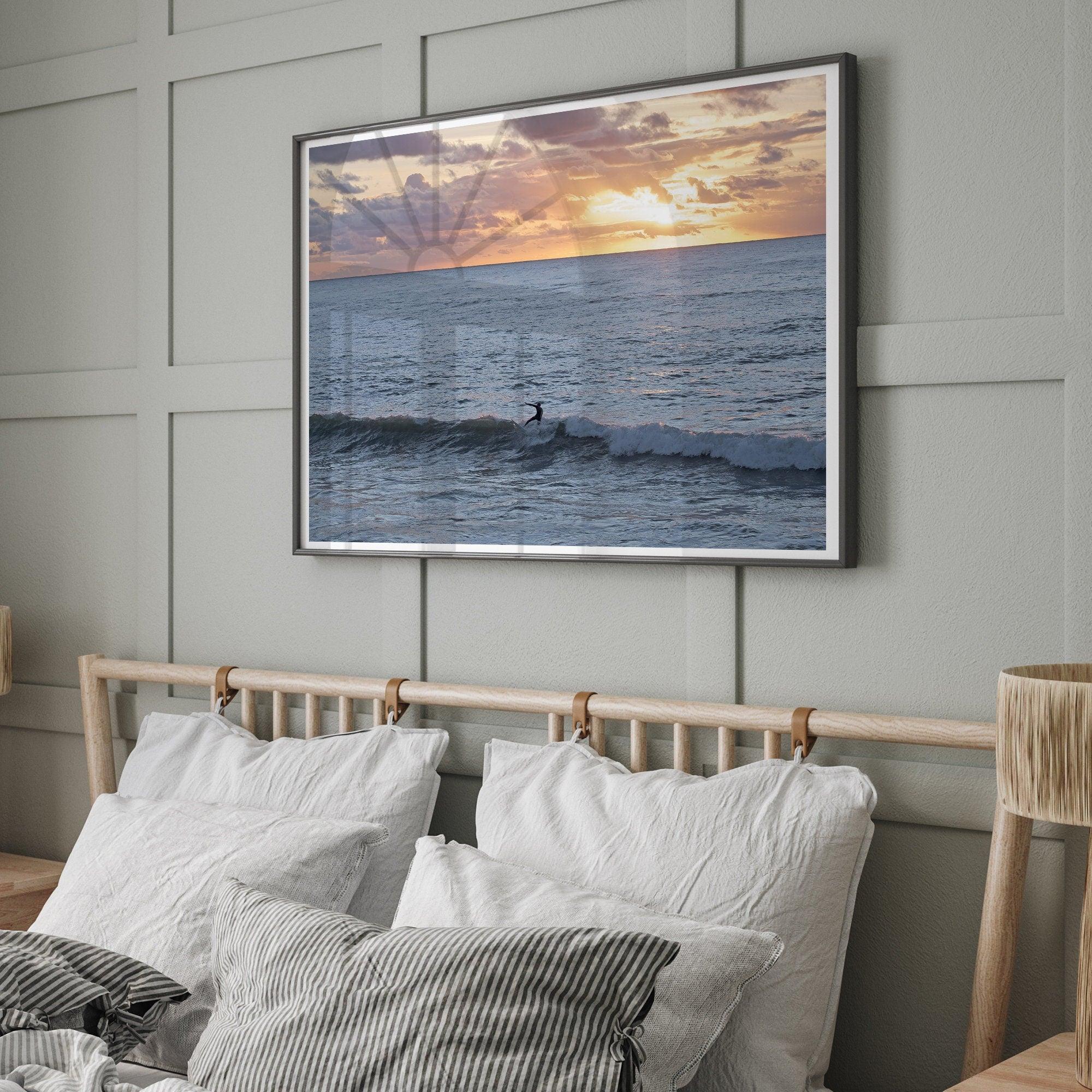 A fine art ocean sunset print showcasing a serene sunset and a lone surfer riding the waves. Taken in Montana De Oro State Park, California.