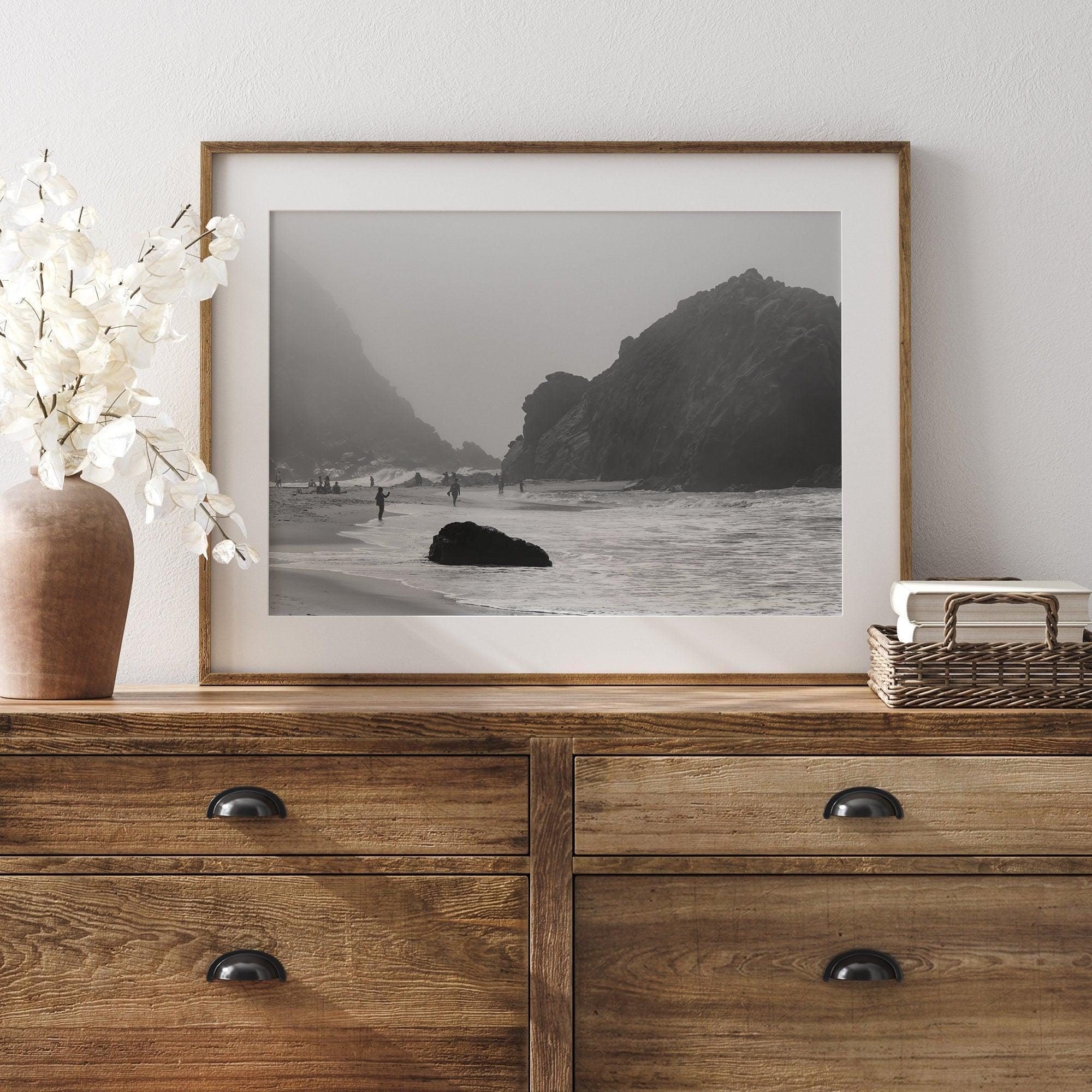 A framed black and white print of the beautiful Pfeiffer Beach in Big Sur hung in the living room. This wall art showcases the dramatic rocks and mist of the Big Sur coastline and the day-to-day life of the beach.