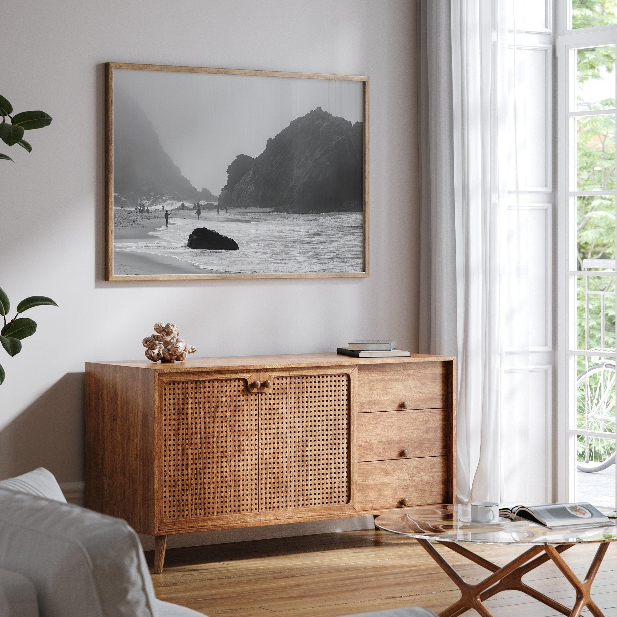 A framed black and white print of the beautiful Pfeiffer Beach in Big Sur hung in the living room. This wall art showcases the dramatic rocks and mist of the Big Sur coastline and the day-to-day life of the beach.