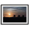 Step into Venice Beach with our fine art beach sunset framed or unframed print. The print showcases the beach in sunset with the silhouettes of the famous lifeguard towers and people in the sunset.