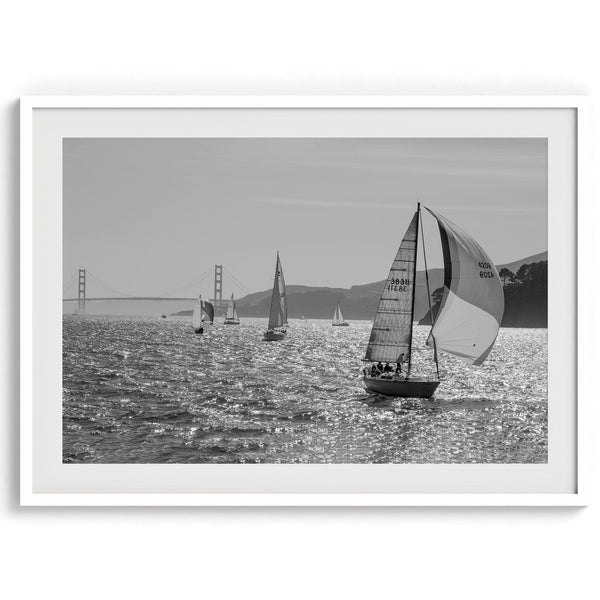 A fine art black and white framed or unframed print of the sailboats in the San Francisco Bay with the backdrop of the Golden Gate Bridge.