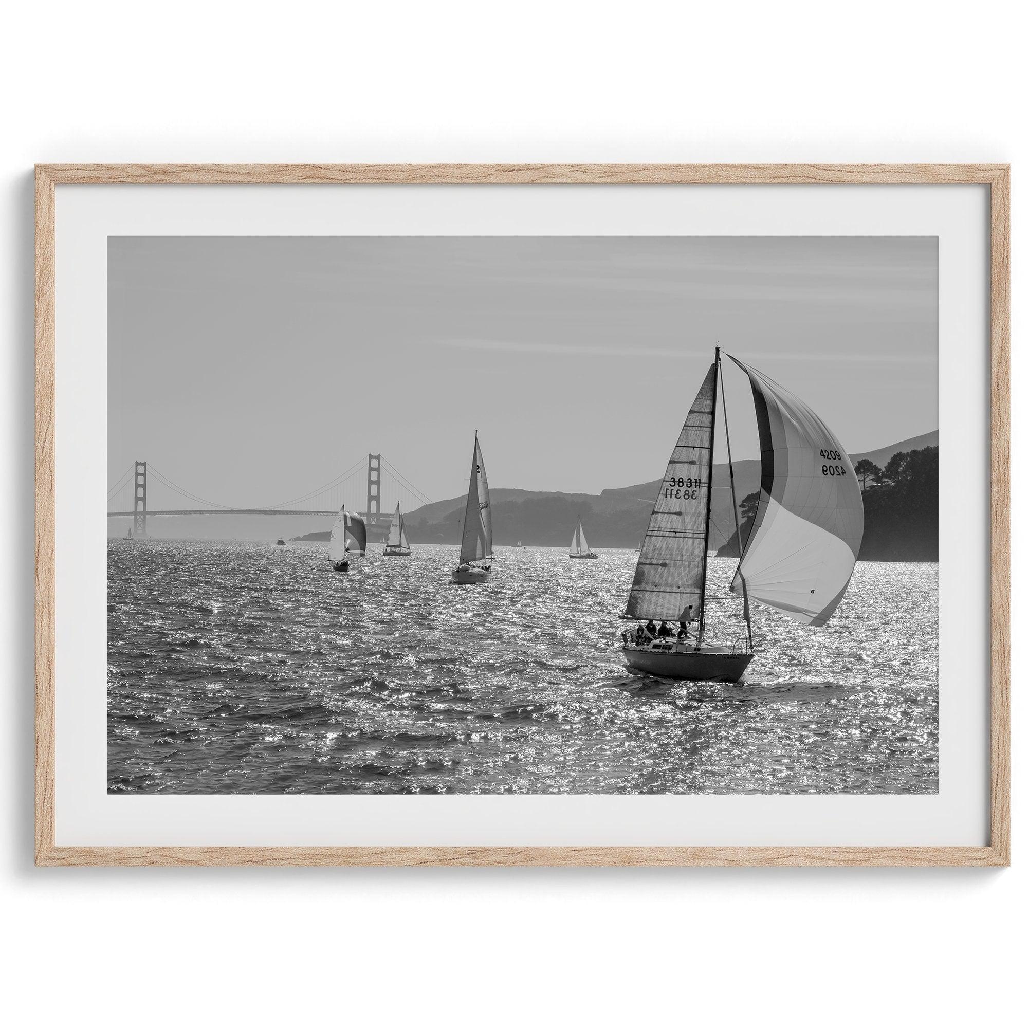 A fine art black and white framed or unframed print of the sailboats in the San Francisco Bay with the backdrop of the Golden Gate Bridge.