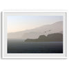 This fine art coastal photography print showcases two birds majestically flying over the Pacific Ocean towards the layered Marin mountains in the sunset. On one of the ridges, there is a lighthouse. The photo was taken from Lands End San Francisco.