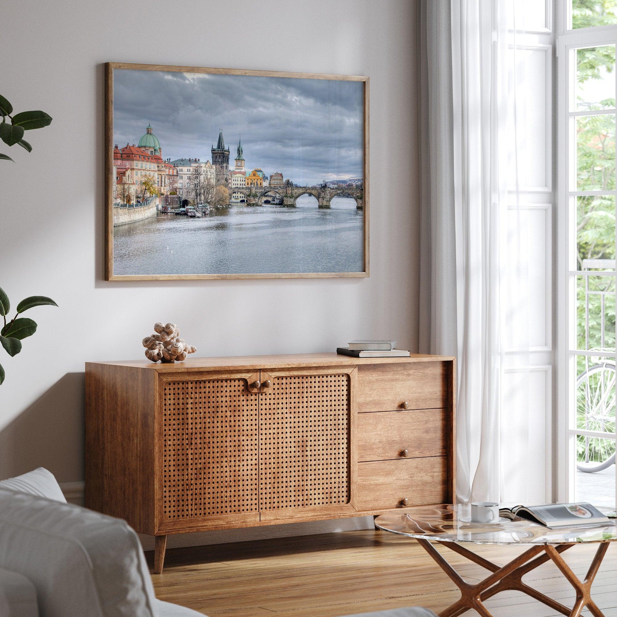 This Prague wall art is a fine art photography print of Charles Bridge against a moody skyline, evoking an old-world painting. Timeless allure captured on archival paper, available in various sizes and frames.