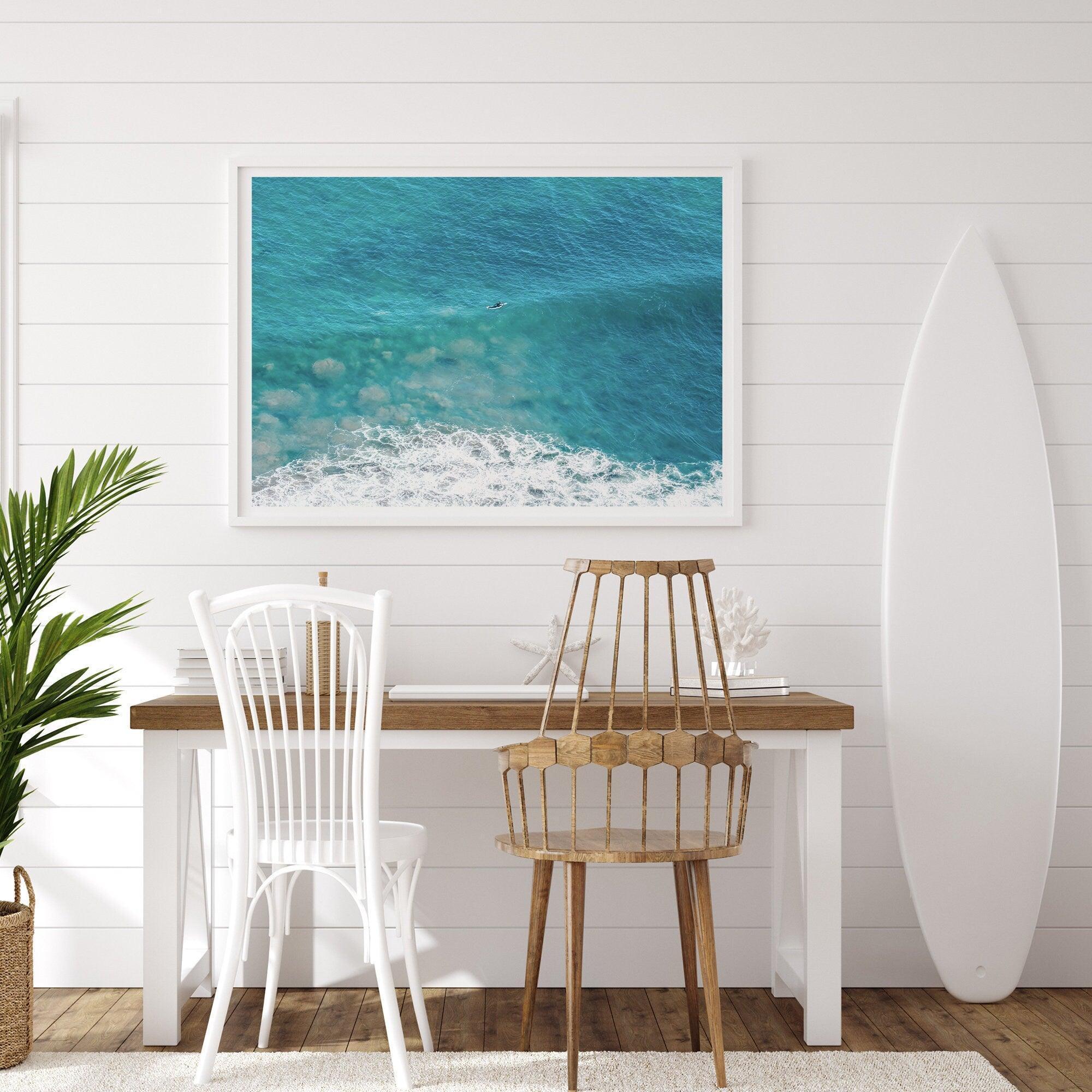 A fine art ocean print of an aerial beach showing a lone surfer with a large wave underneath.