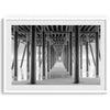 A large fine art abstract black and white beach pier print This stunning beach wall art shows the symmetric structure of the pier with the ocean water gently caressing the pier and beach.