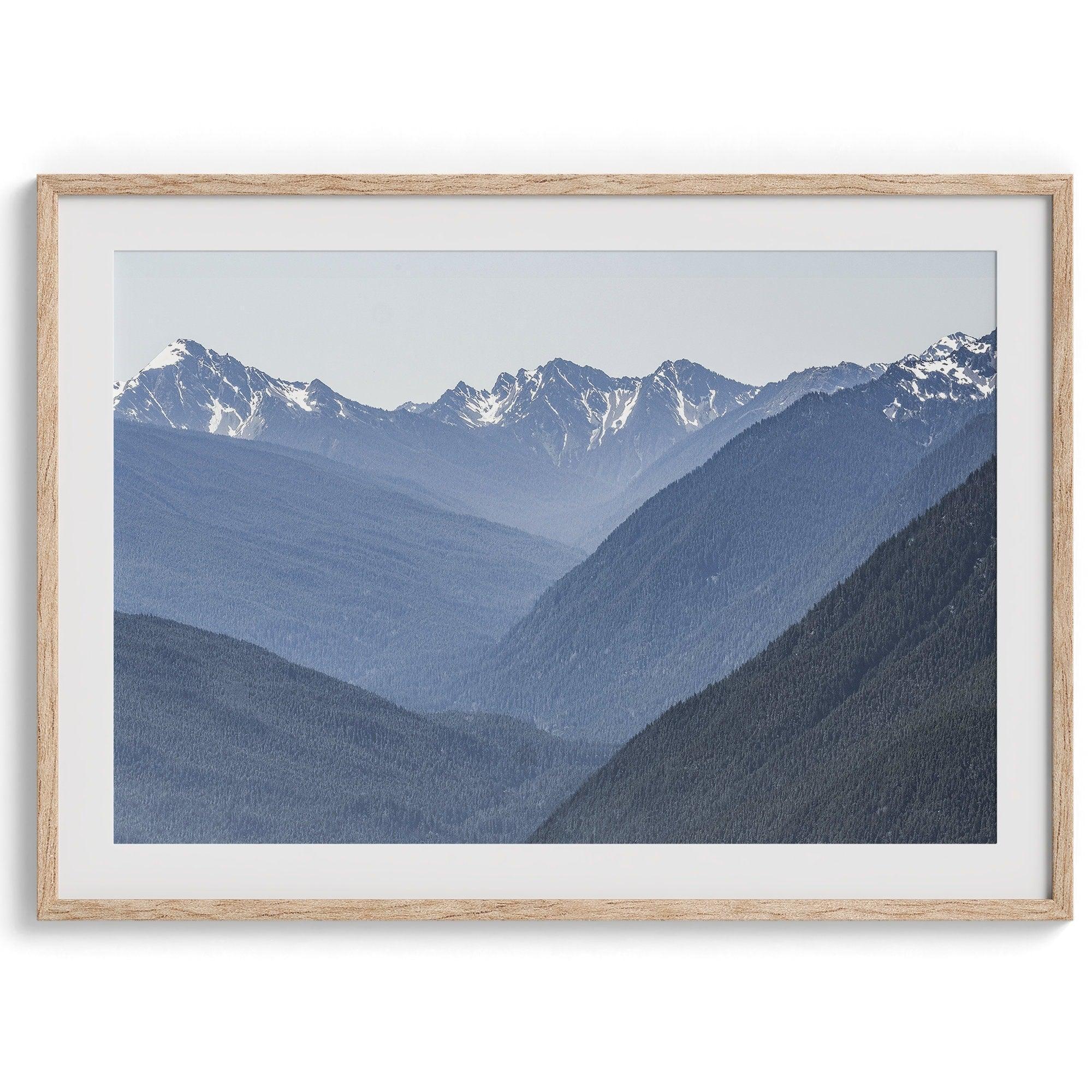 A fine art mountain range print. This mountain wall art showcases the layered misty blue mountains of Olympic National Park in Washington.