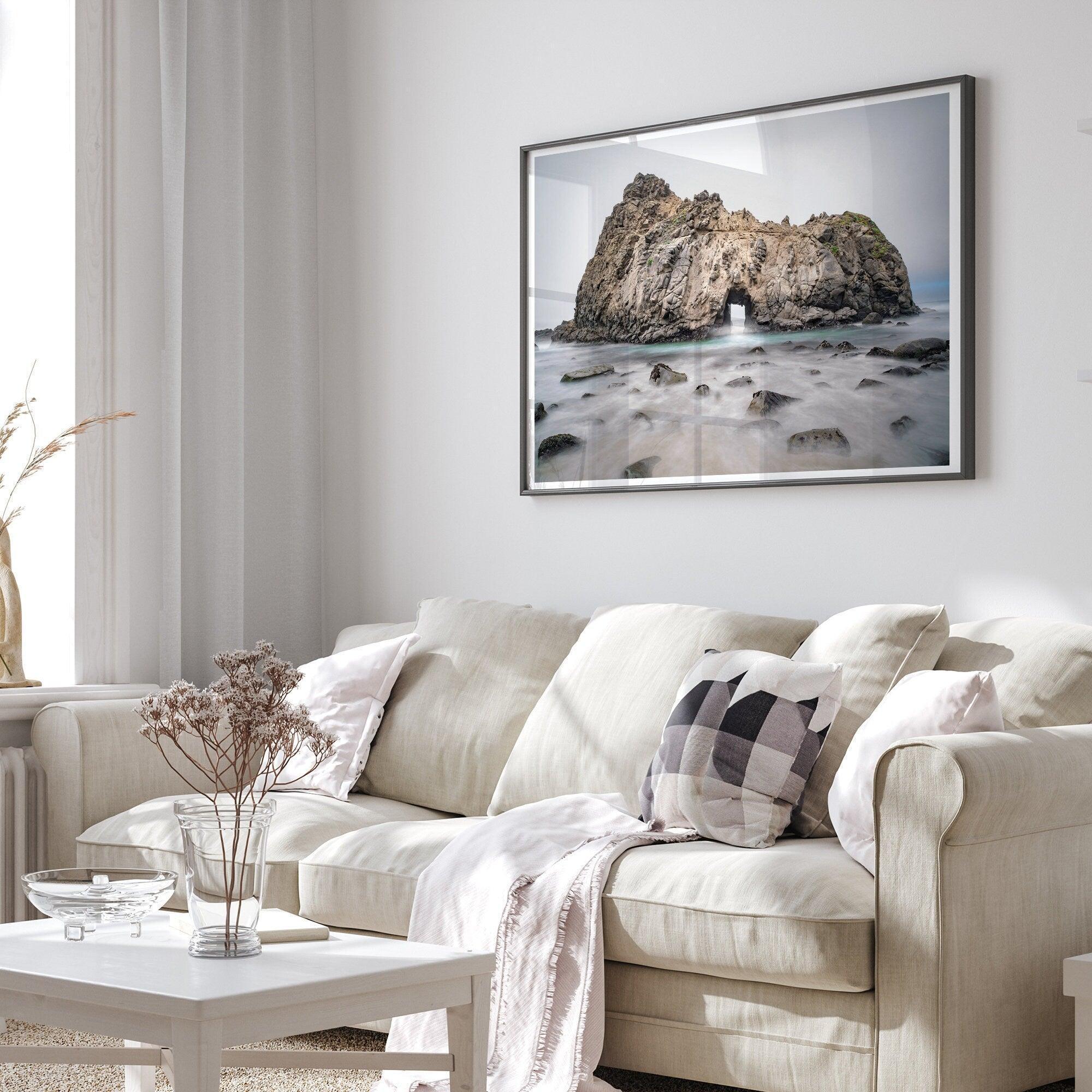 Fine art print showcasing a magnificent rock formation framing the horizon and crashing waves, with scattered rocks adding texture. Captivating and soothing, this print is a timeless addition to any space, evoking relaxation and awe-inspiring beauty.