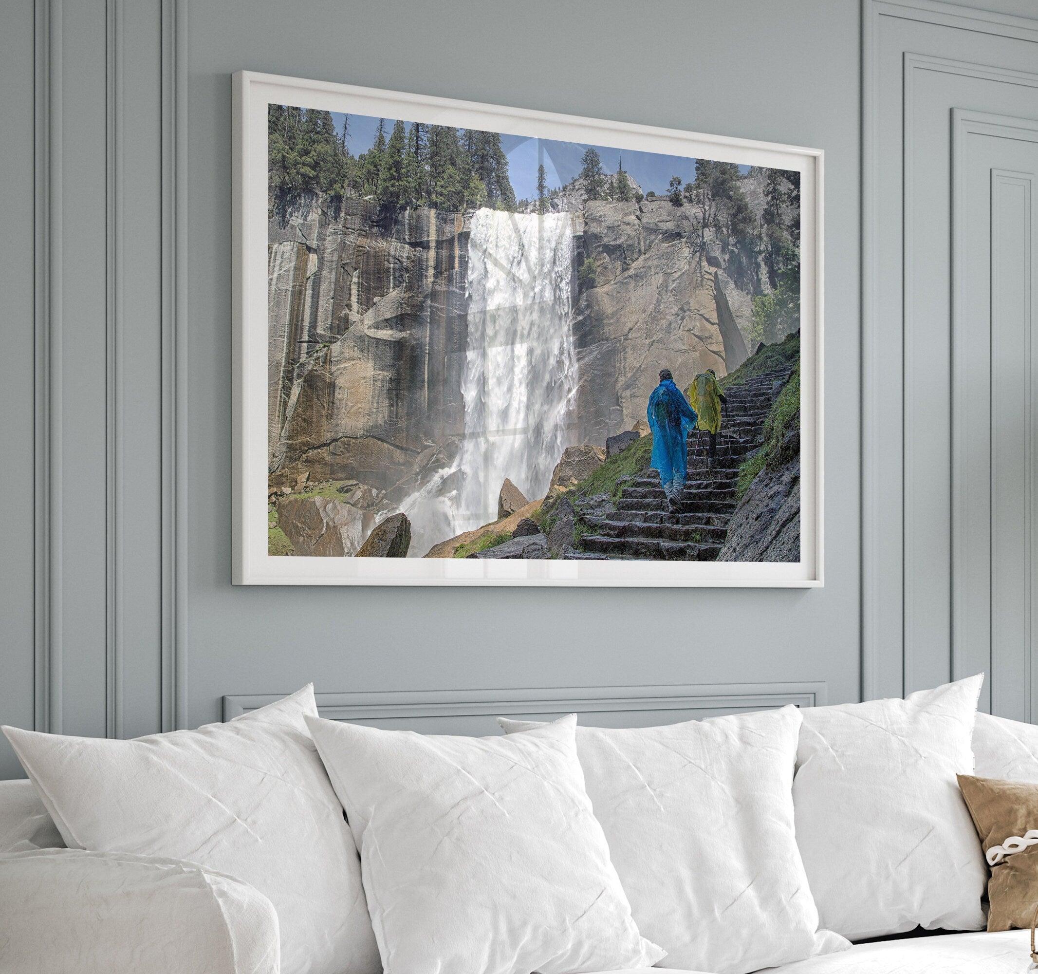 Climb the breathtaking Mist Trail in Yosemite National Part with this fine art waterfall nature print. This nature landscape wall art showcases the stunning gushing waterfall and the people scaling the trail with their colorful raincoats.