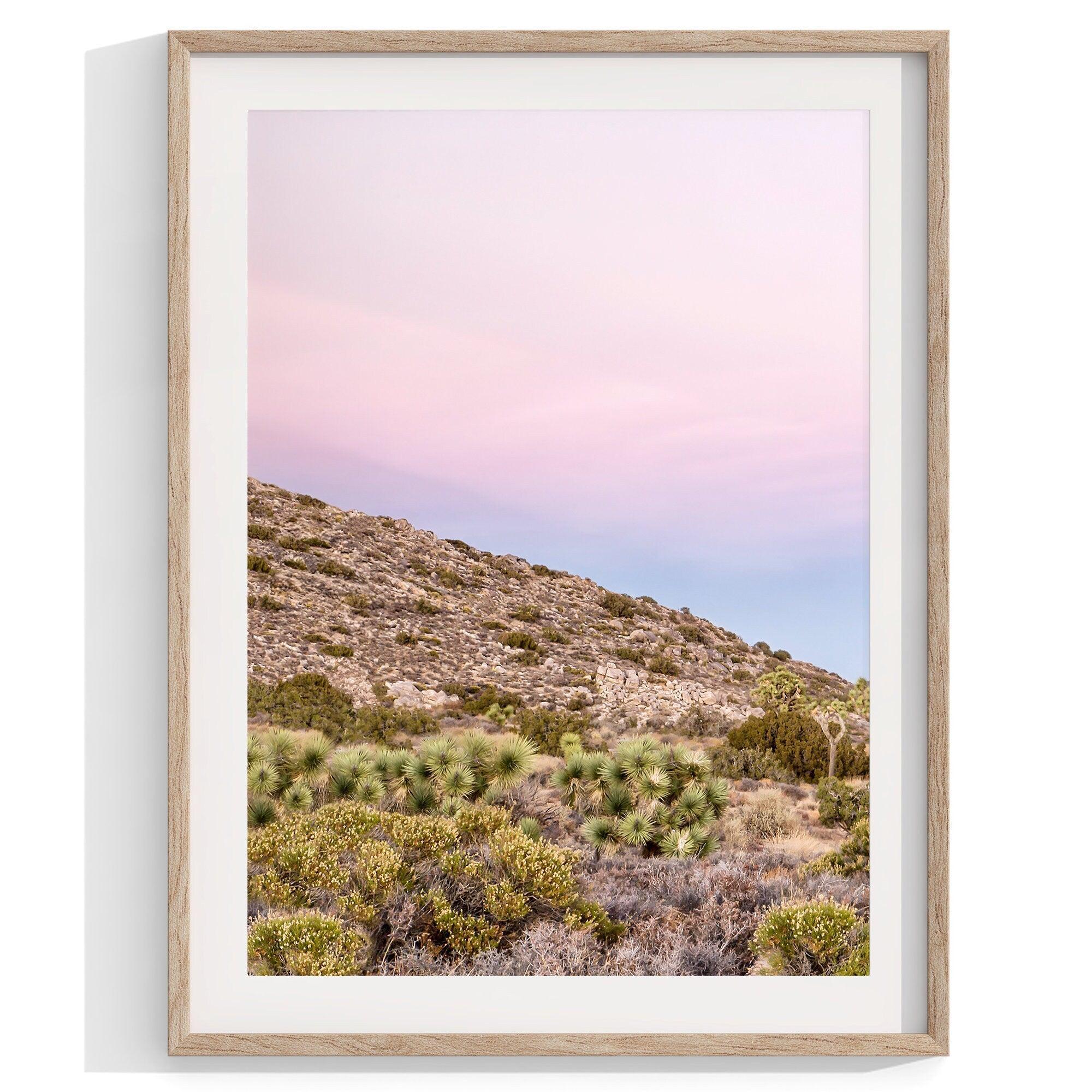 A wall art set of 3 framed or unframed Joshua Tree National Park prints. This desert wall art showcases a stunning Joshua Tree and the desert terrain and plants in a breathtaking Pink sunset filled with Pink and Purple hues. Modern gallery wall set