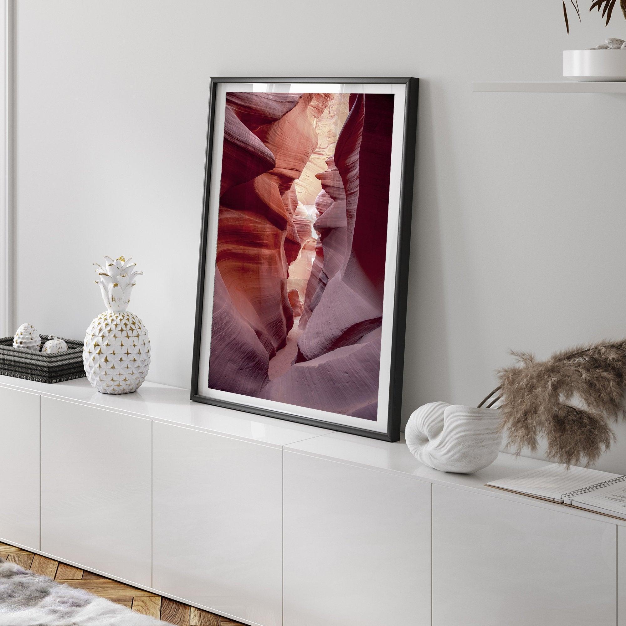 This beautiful Arizona desert wall art captures the mesmerizing beauty of Antelope Canyon. The picture showcases a passage through the rock in the canyon, with vibrant pink and purple textures that create a sense of depth and dimension.