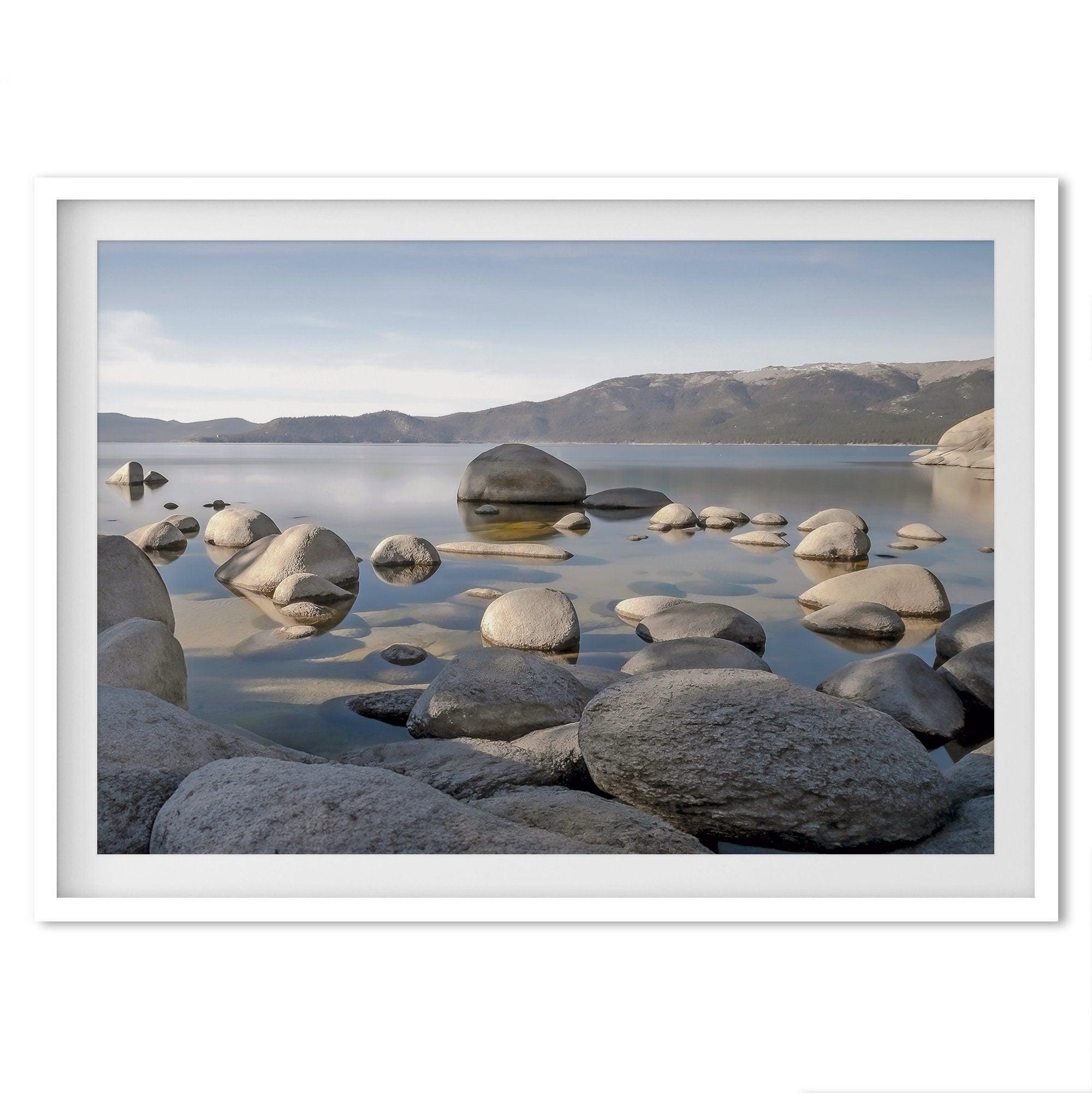 This breathtaking fine art Lake Tahoe print captures the perfect shape of the huge rocks that rise from the crystal-clear water, creating a beautiful contrast against the blue sky and the distant mountain range.