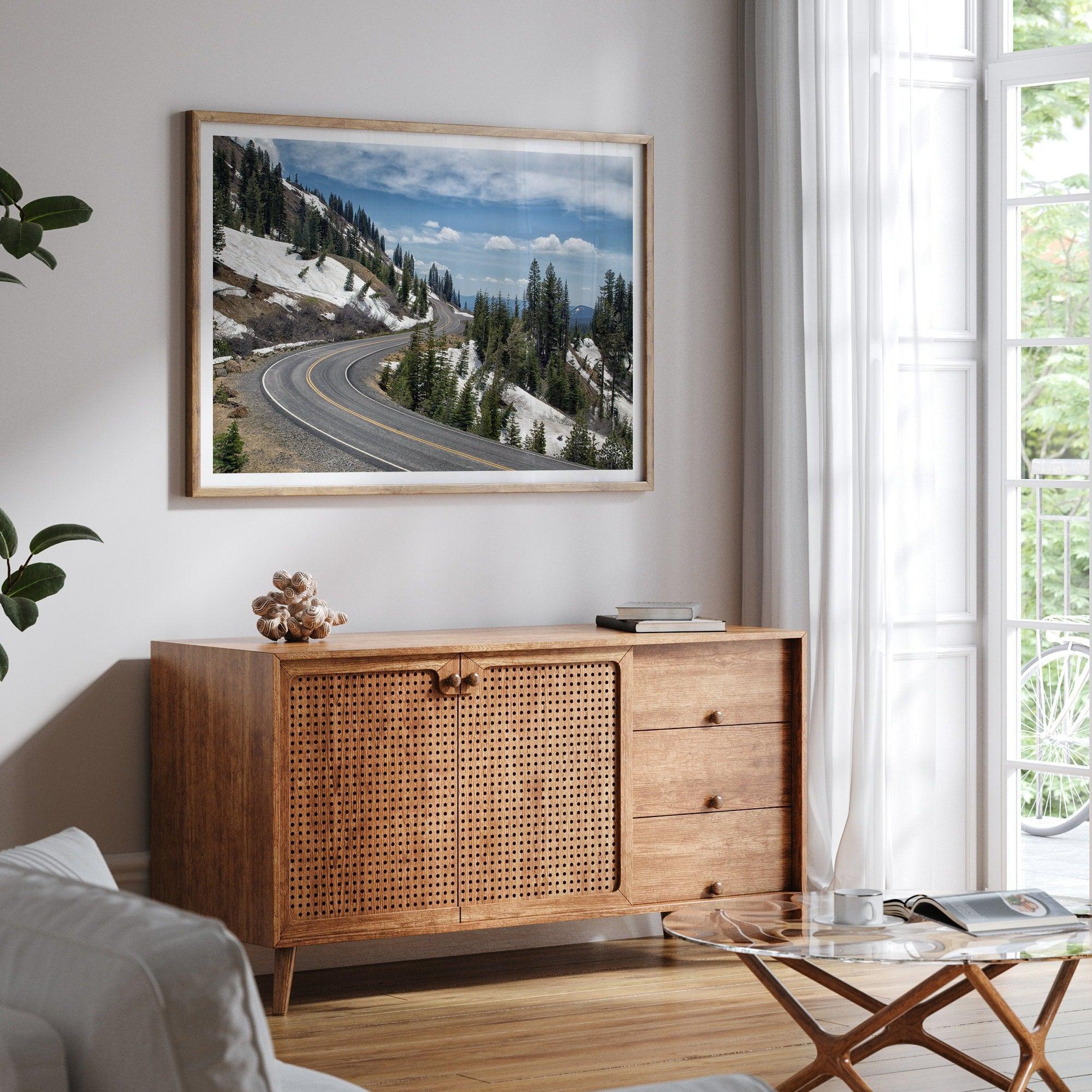 An unframed or framed fine art print of a mountain in Lassen National Park, Featuring a winding road through the lush forest and snow covered mountain.