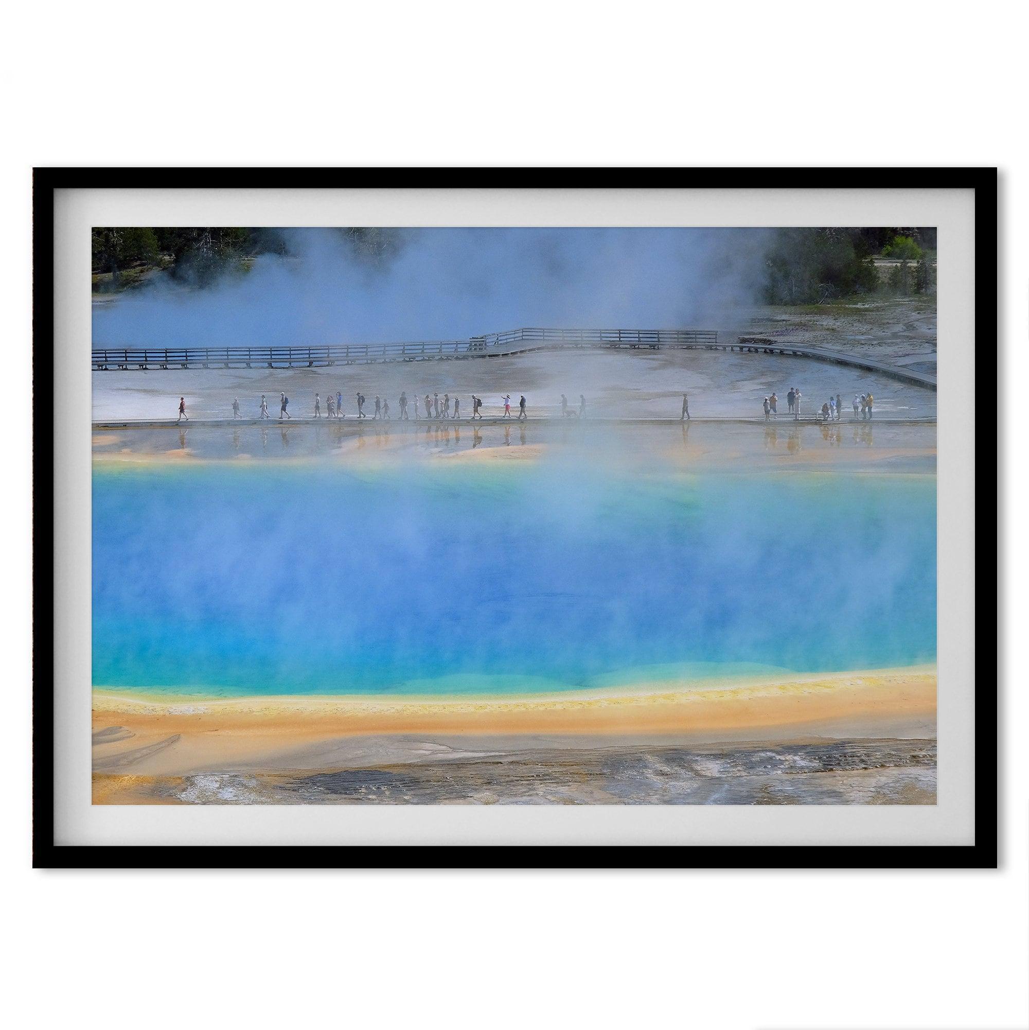 A fine art colorful photography print of Grand Prismatic Hot Springs in Yellowstone National Park. The picture shows the scale of the hot springs next to the people walking next to it.