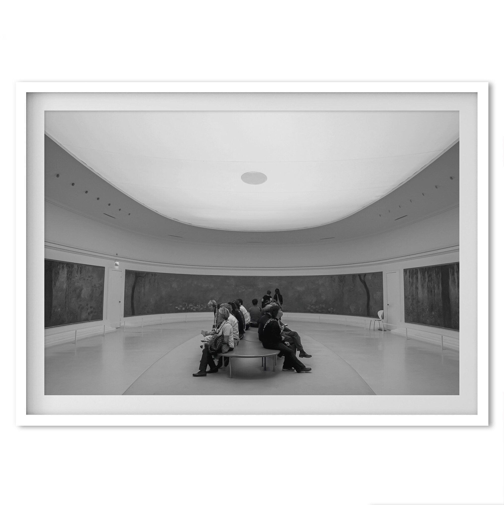 This unique black and white fine art Paris photo print transports you to the heart of the Musée d'Orsay in Paris, the center of the Impressionist movement. This Paris wall art showcases spectators sitting in the middle of the Monet exhibition.