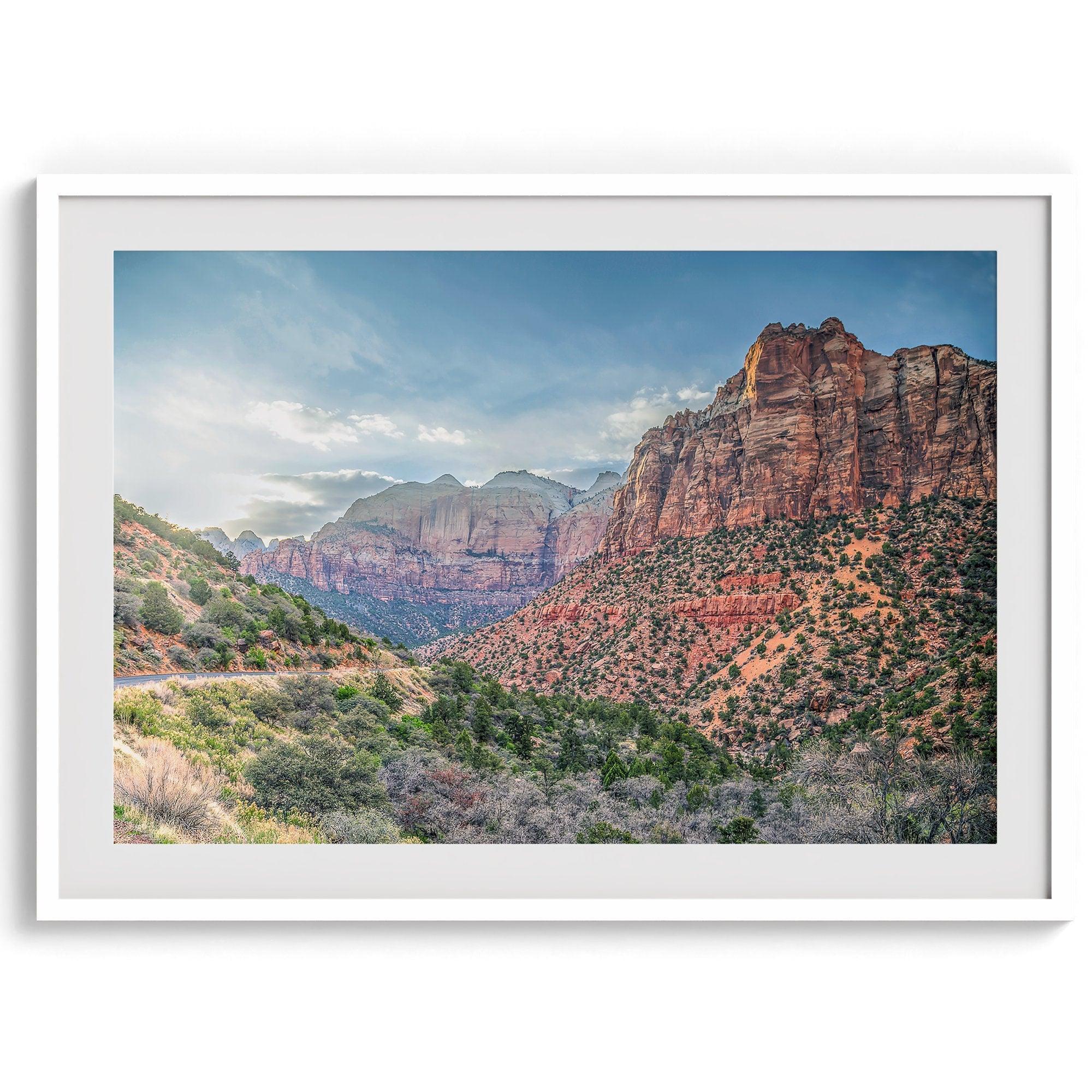 A fine art desert print from Zion National Park showcasing a stunning towering cliff and winding road.