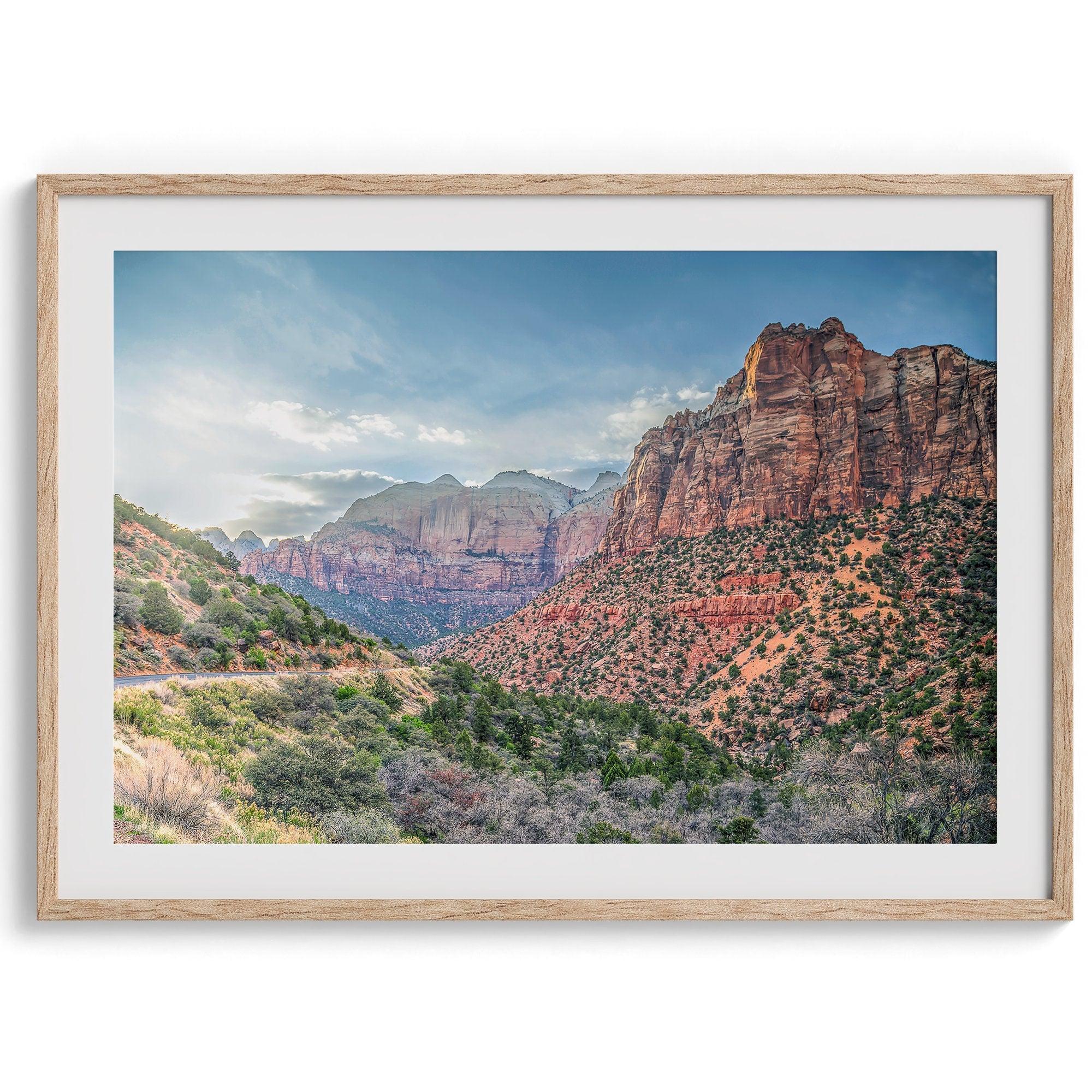 A fine art desert print from Zion National Park showcasing a stunning towering cliff and winding road.