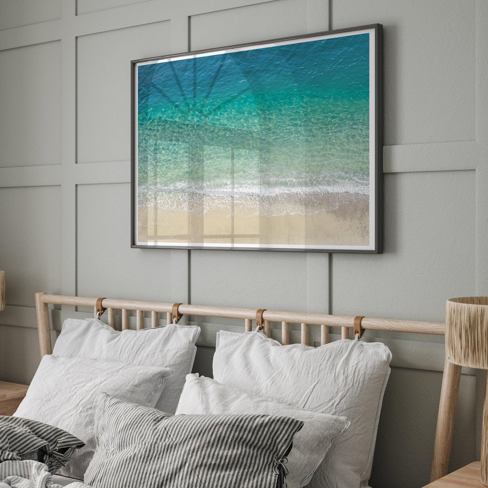 This fine art aerial beach print showcases the mesmerizing colors of the ocean in vivid detail. From the deep blue depths to the vibrant greenish turquoise blue, transitioning to the golden sandy beach and the crashing white surf.