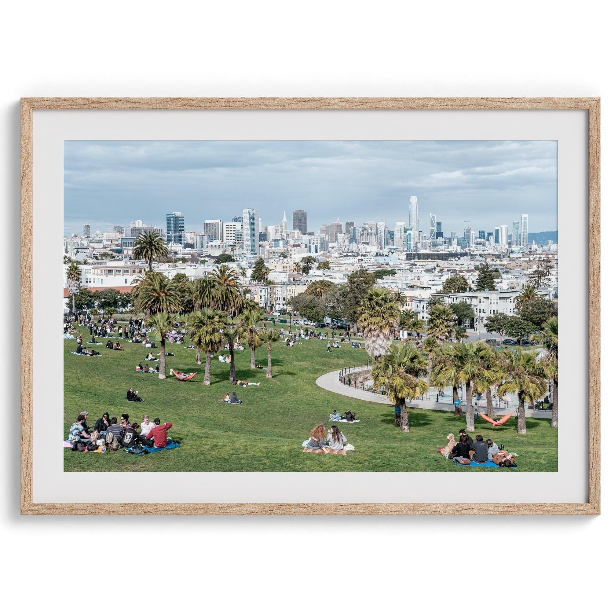 A fine art unframed or framed San Francisco print of Mission Dolores Park showcasing picnic blankets and people enjoying a quiet afternoon with the city skyline in the backdrop.