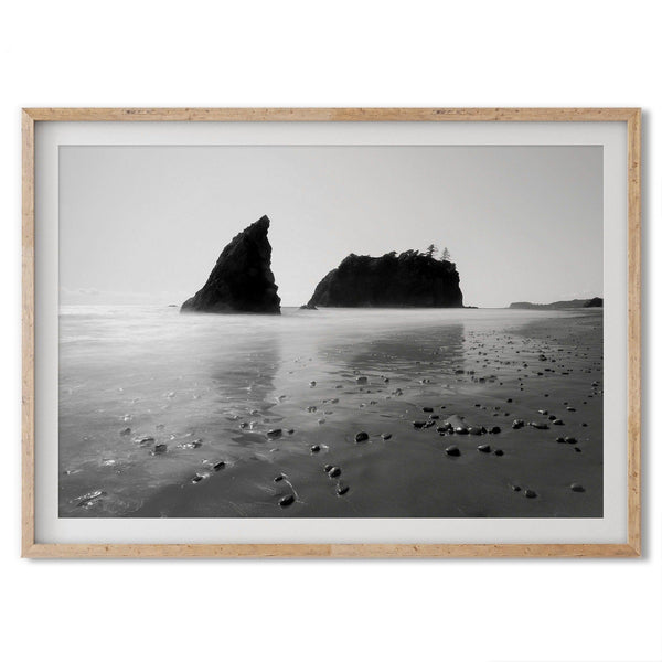 A fine art print of Ruby Beach in Olympic National Park, Washington. This black and white beach wall art features creamy waves in long exposure and dark-shaded towering rocks emerging from the ocean.