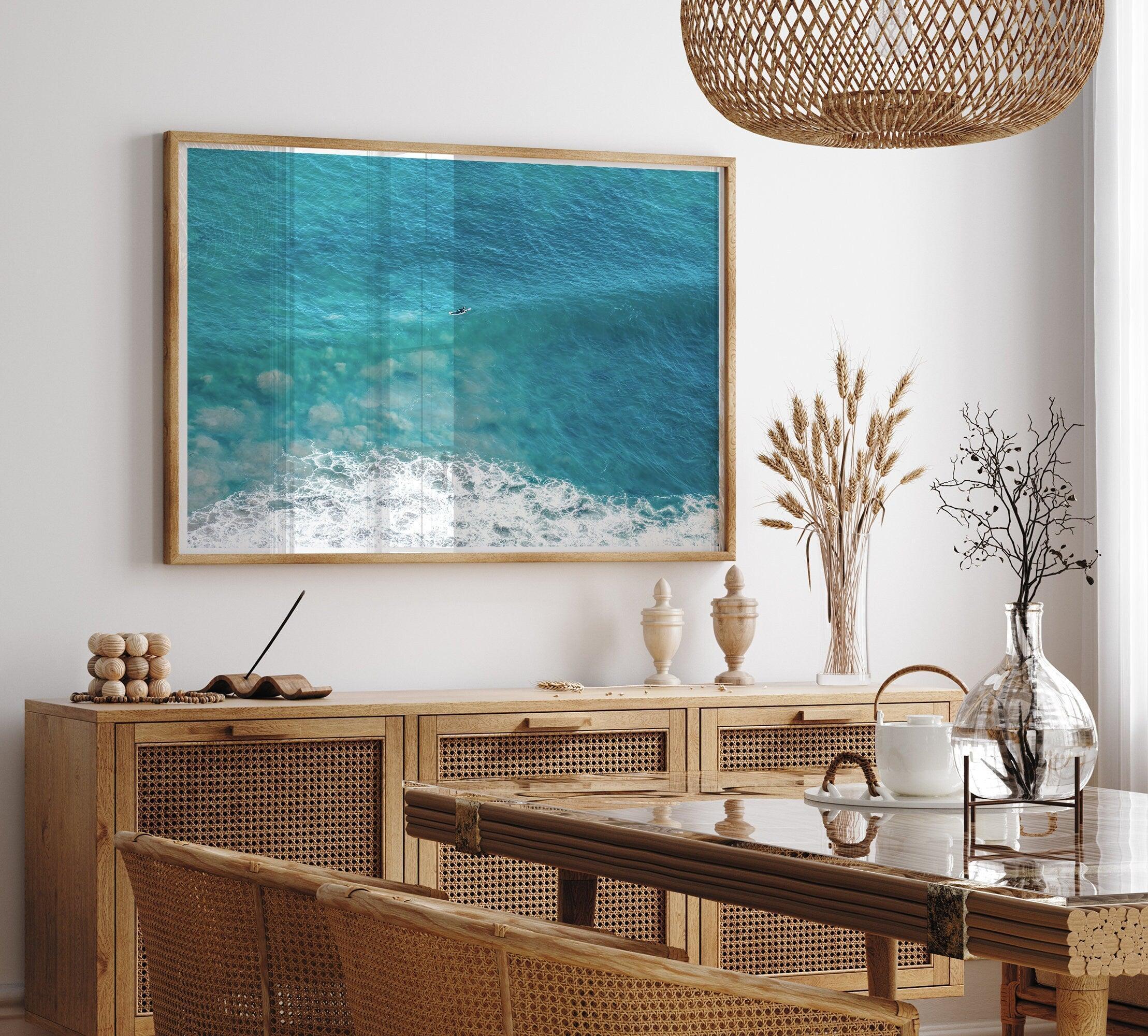 A fine art ocean print of an aerial beach showing a lone surfer with a large wave underneath.