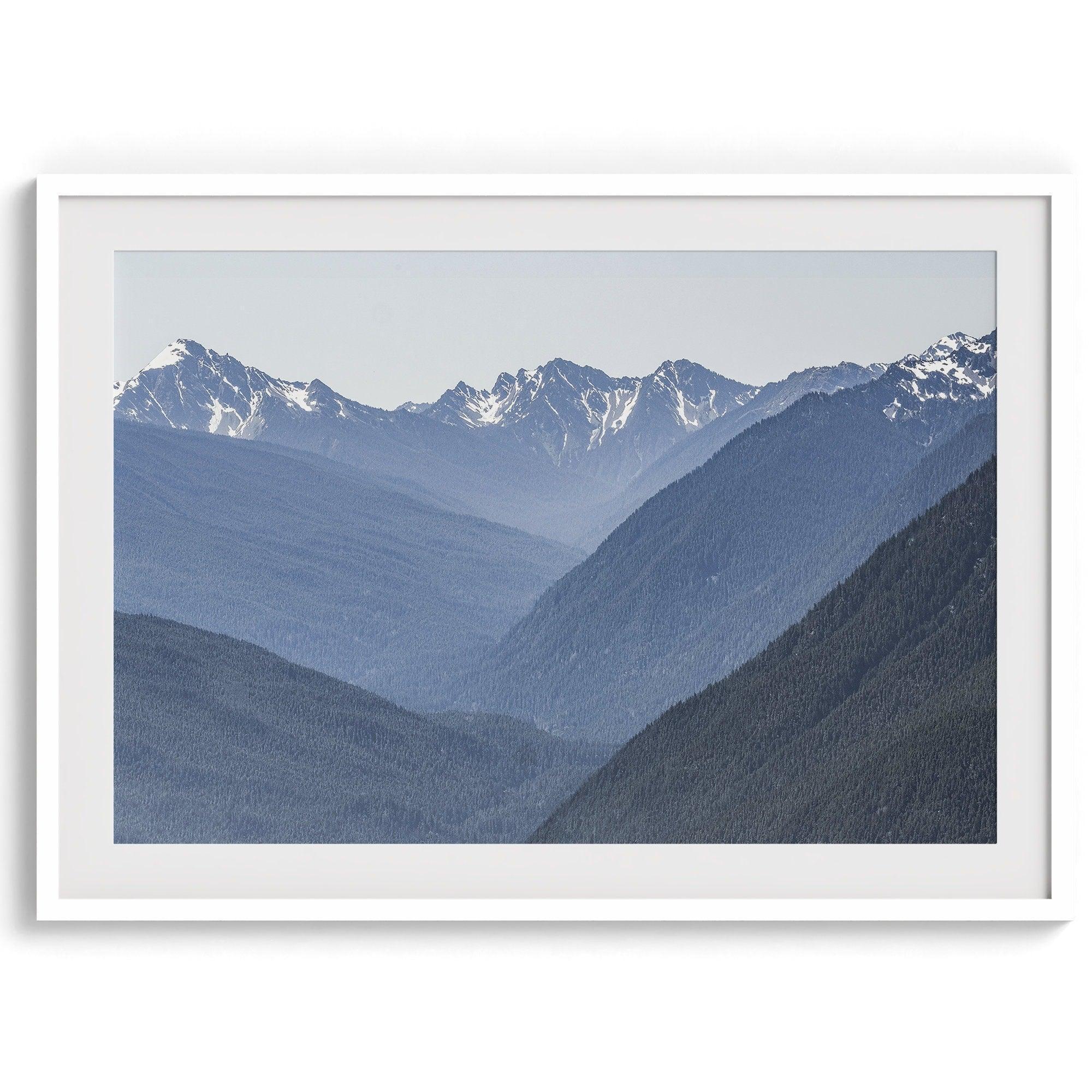 A fine art mountain range print. This mountain wall art showcases the layered misty blue mountains of Olympic National Park in Washington.