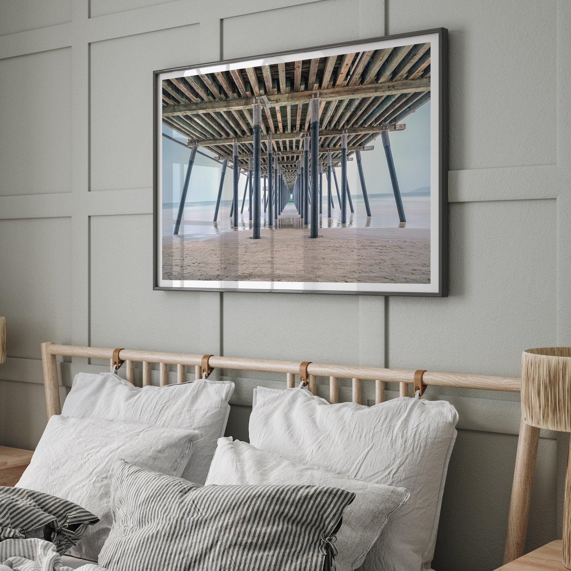 A fine art boho style beach photography print featuring a view from below Pismo Beach Pier.