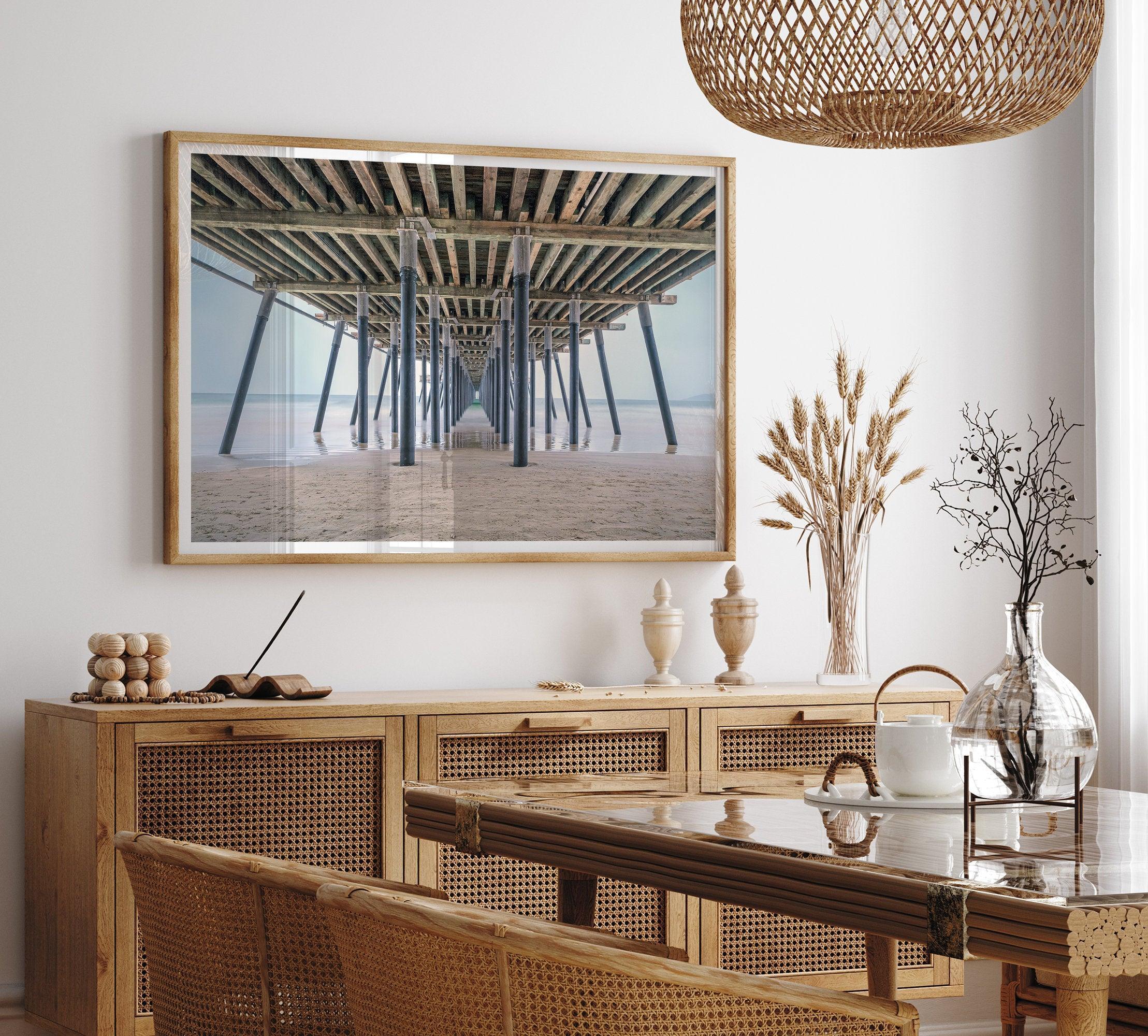 A fine art boho style beach photography print featuring a view from below Pismo Beach Pier.