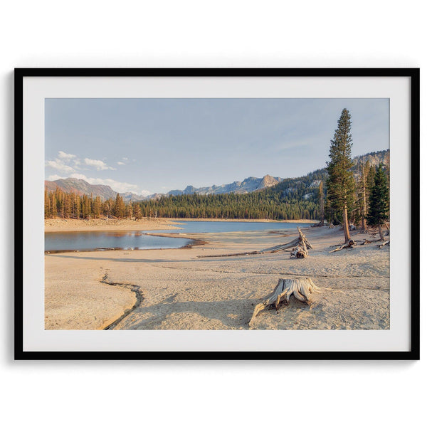 A framed lake print capturing the unique landscape of Horseshoe Lake in the Mammoth Lakes area. This Pacific Northwest wall art showcases the barren ground around the lake and the lush forests and majestic mountains of the Eastern Sierra region.