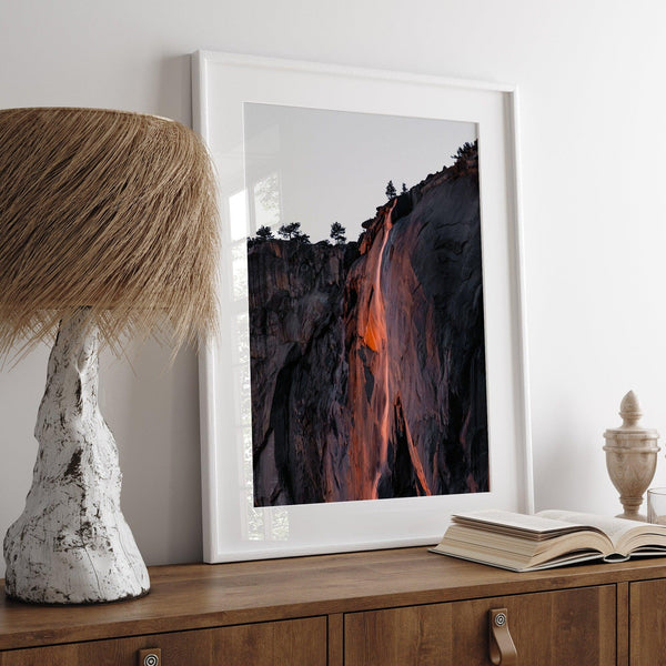 This premium photography framed or unframed fine poster print of Yosemite National Park Firefall - a rare phenomenon where Horsetail Falls in Yosemite seems to be flowing with fire rather than water.